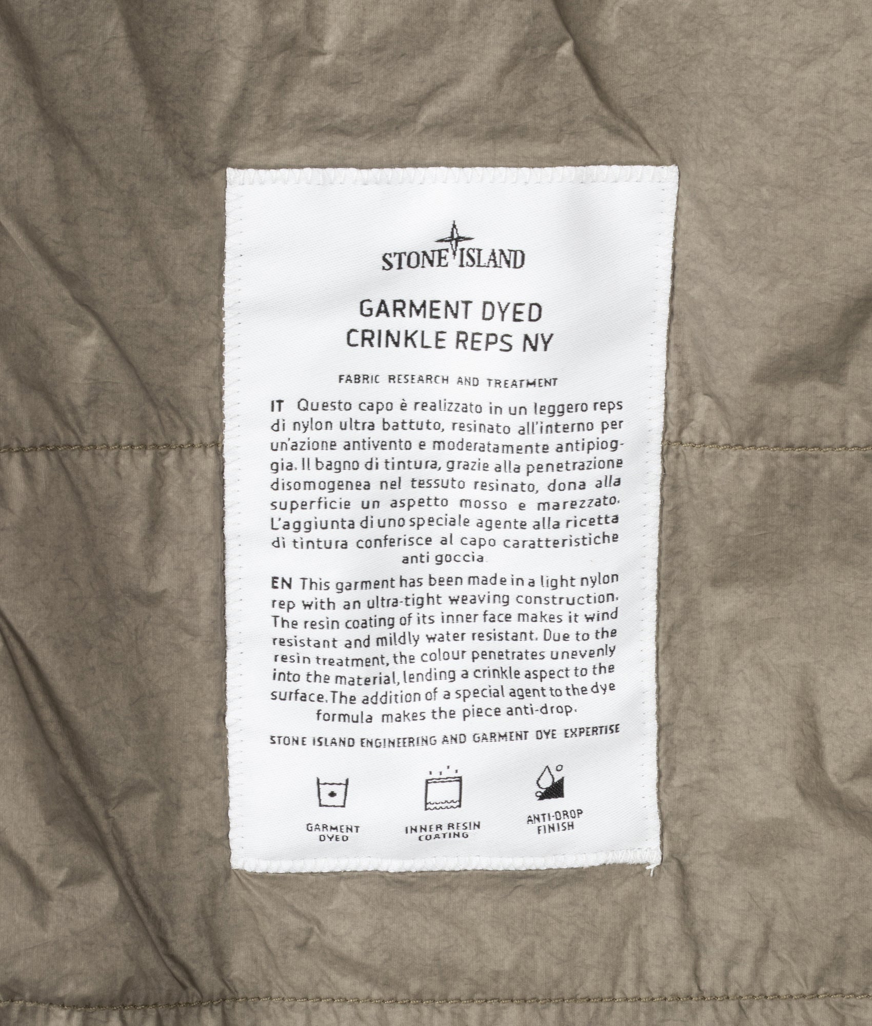 Stone Island Crinkle Reps NY Jacket in Military Green at EQVVS Menswear. Label shot.