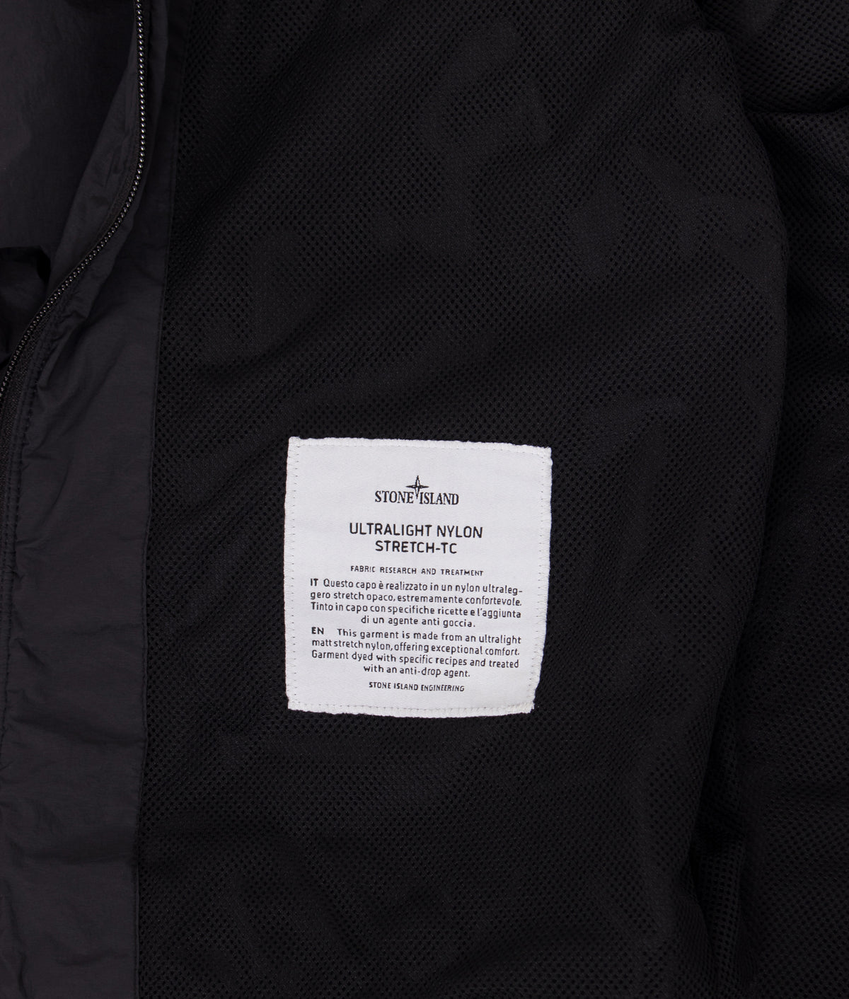 Stone Island Ultralight Nylon Stretch-TC Jacket in Black at EQVVS Menswear. Label shot.