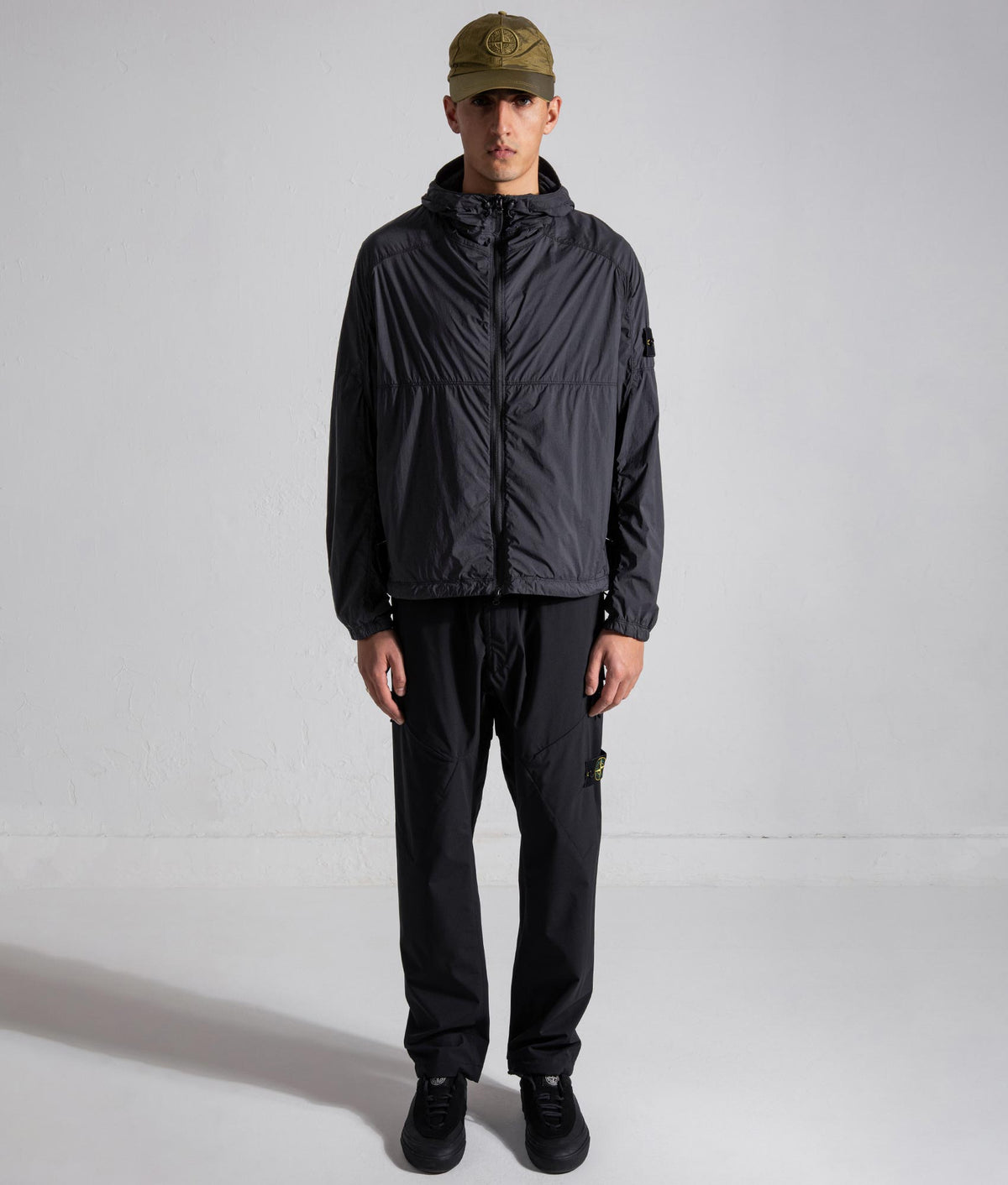 Stone Island Ultralight Nylon Stretch-TC Jacket in Black at EQVVS Menswear. Model front shot.