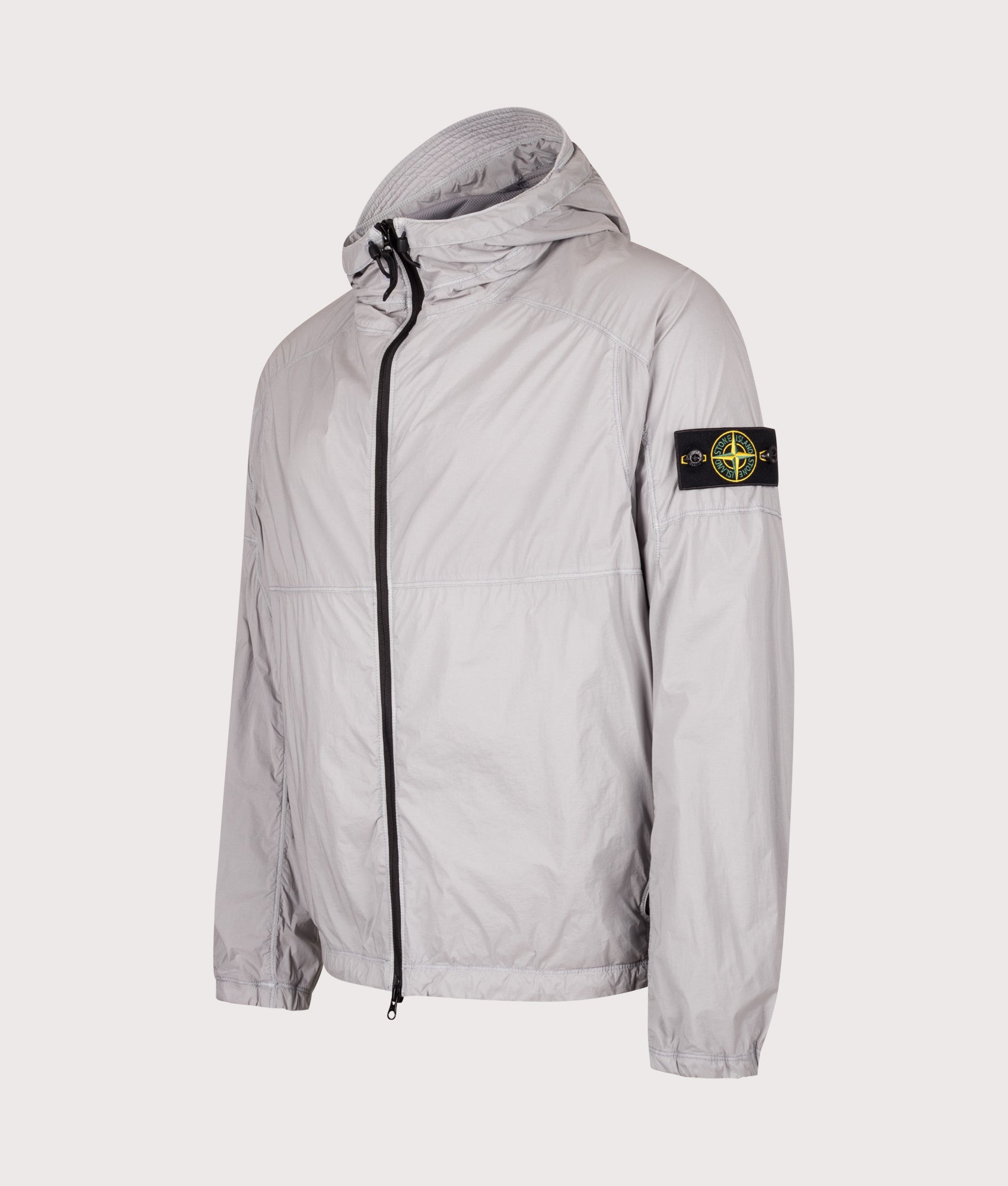 Stone Island Ultralight Nylon Stretch-TC Jacket in Ash Grey at EQVVS Menswear. Angled front shot.