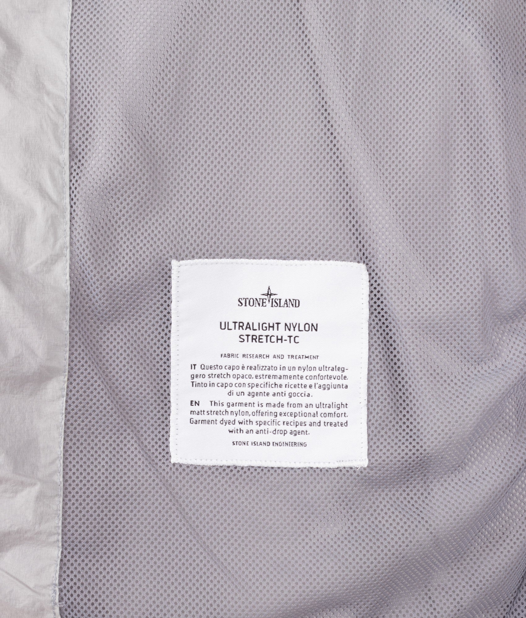 Stone Island Ultralight Nylon Stretch-TC Jacket in Ash Grey at EQVVS Menswear. Label shot.