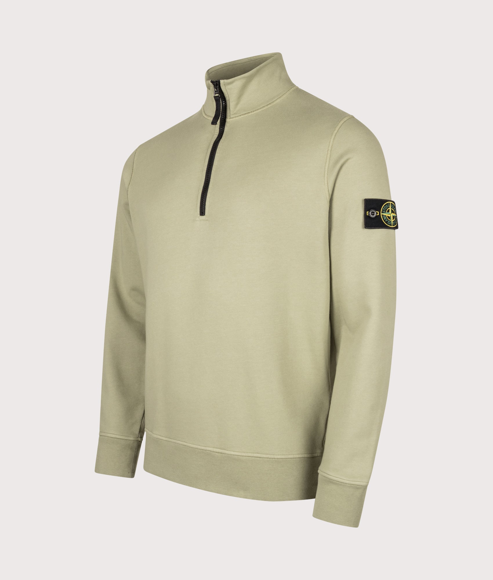 Stone Island Organic Cotton Fleece Quarter Zip Sweatshirt in Laurel Green at EQVVS Menswear. Angled front shot.