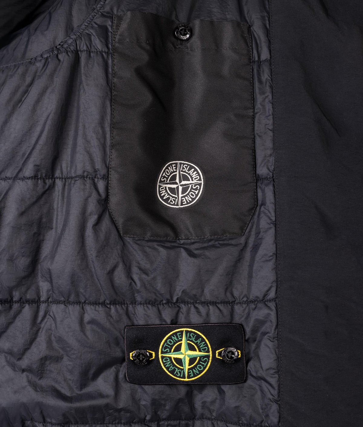 Stone Island Crinkle Reps NY Jacket in Black at EQVVS Menswear. Internal badge and sleeve badge stash buttons.