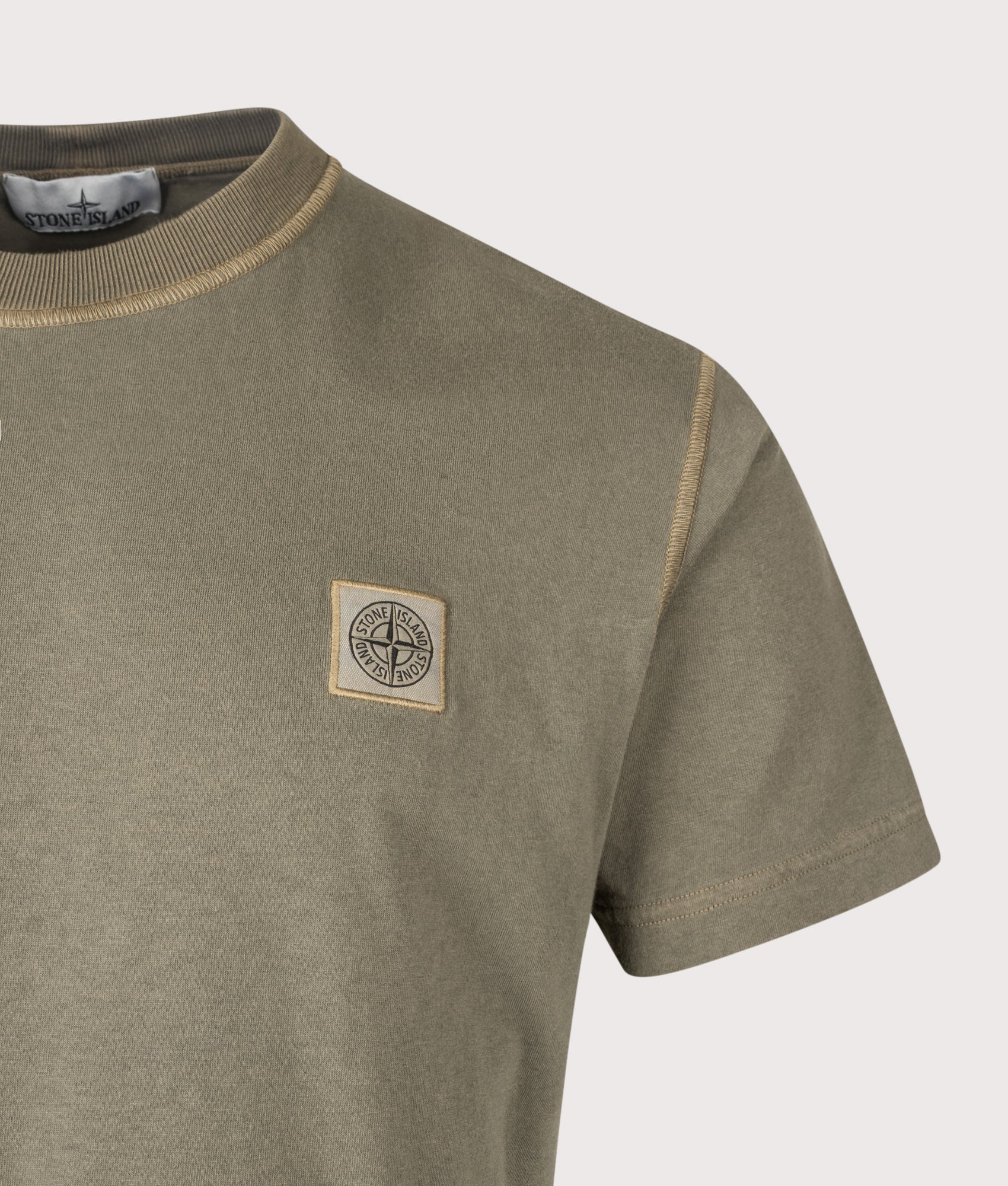 Stone Island Slim Fit Organic Cotton 'FISSATO' Effect T-Shirt in Military Green at EQVVS Menswear. Detail shot.