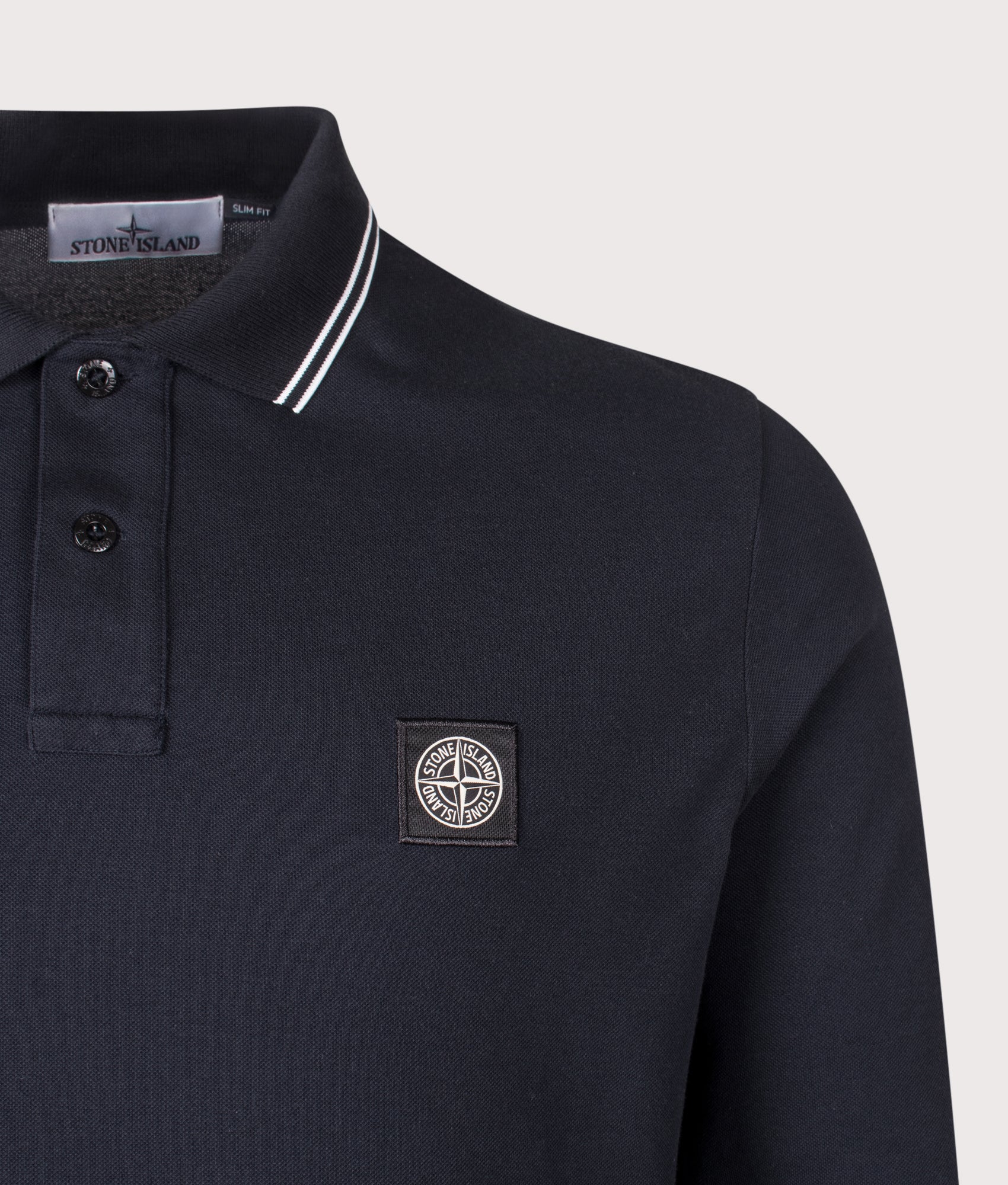 Stone Island Slim Fit Long Sleeve Polo Shirt in Navy Blue at EQVVS Menswear. Detail shot.