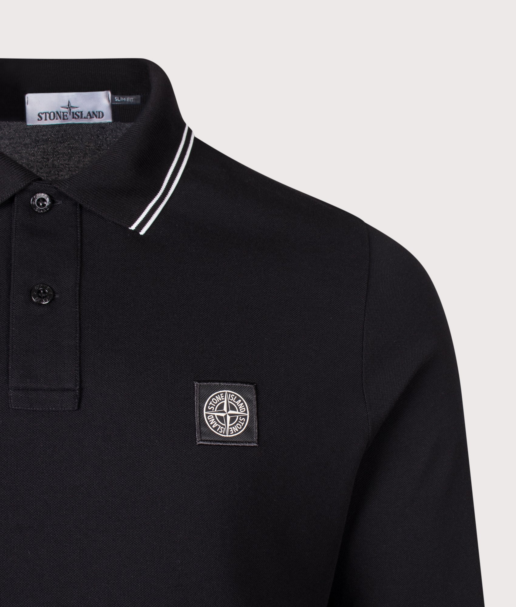 Stone Island Slim Fit Long Sleeve Polo Shirt in Black at EQVVS Menswear. Detail shot.