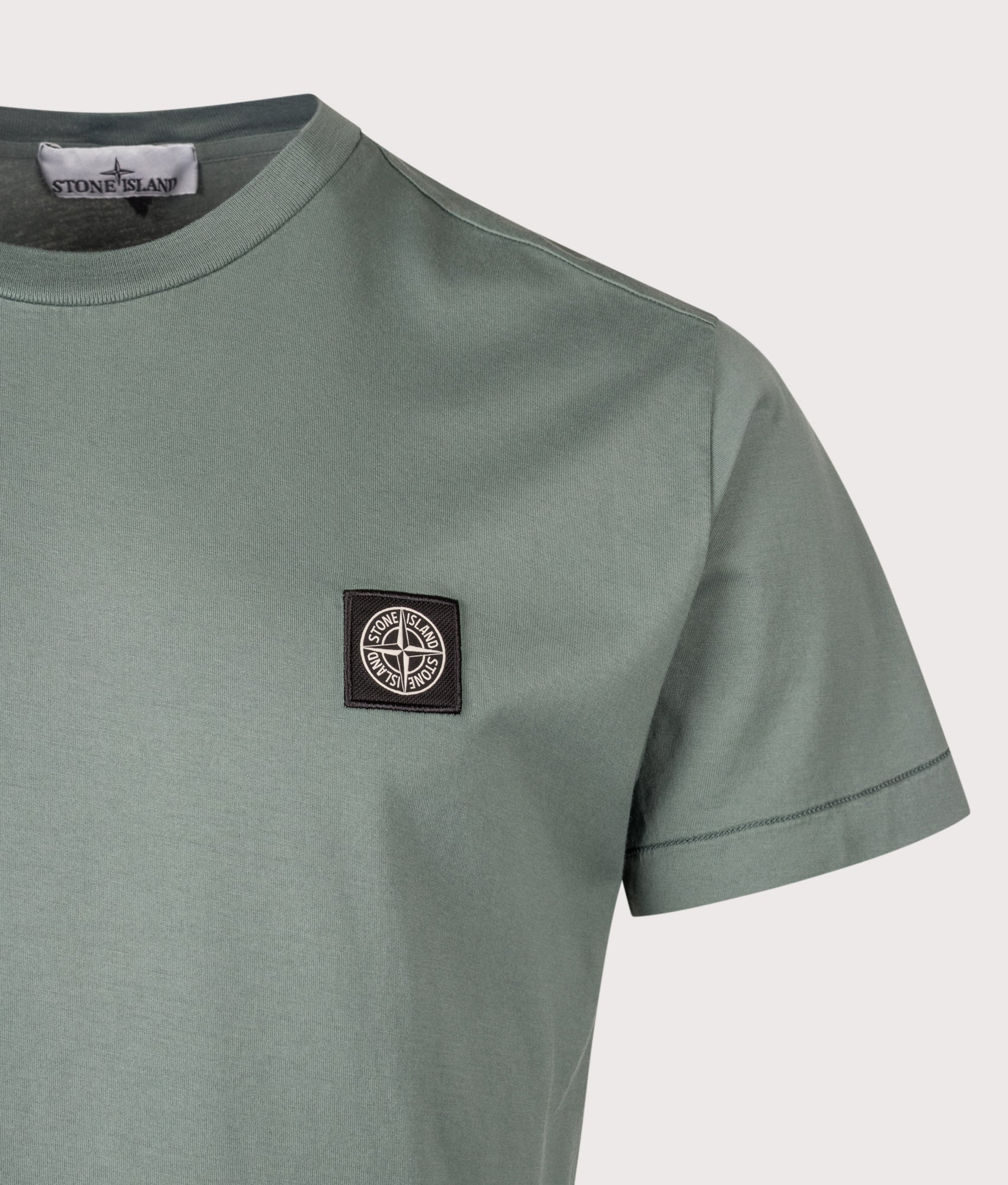 Stone Island piece Slim Fit 60/2 Cotton Jersey T-Shirt in Ocean Green at EQVVS Menswear. Detail shot.