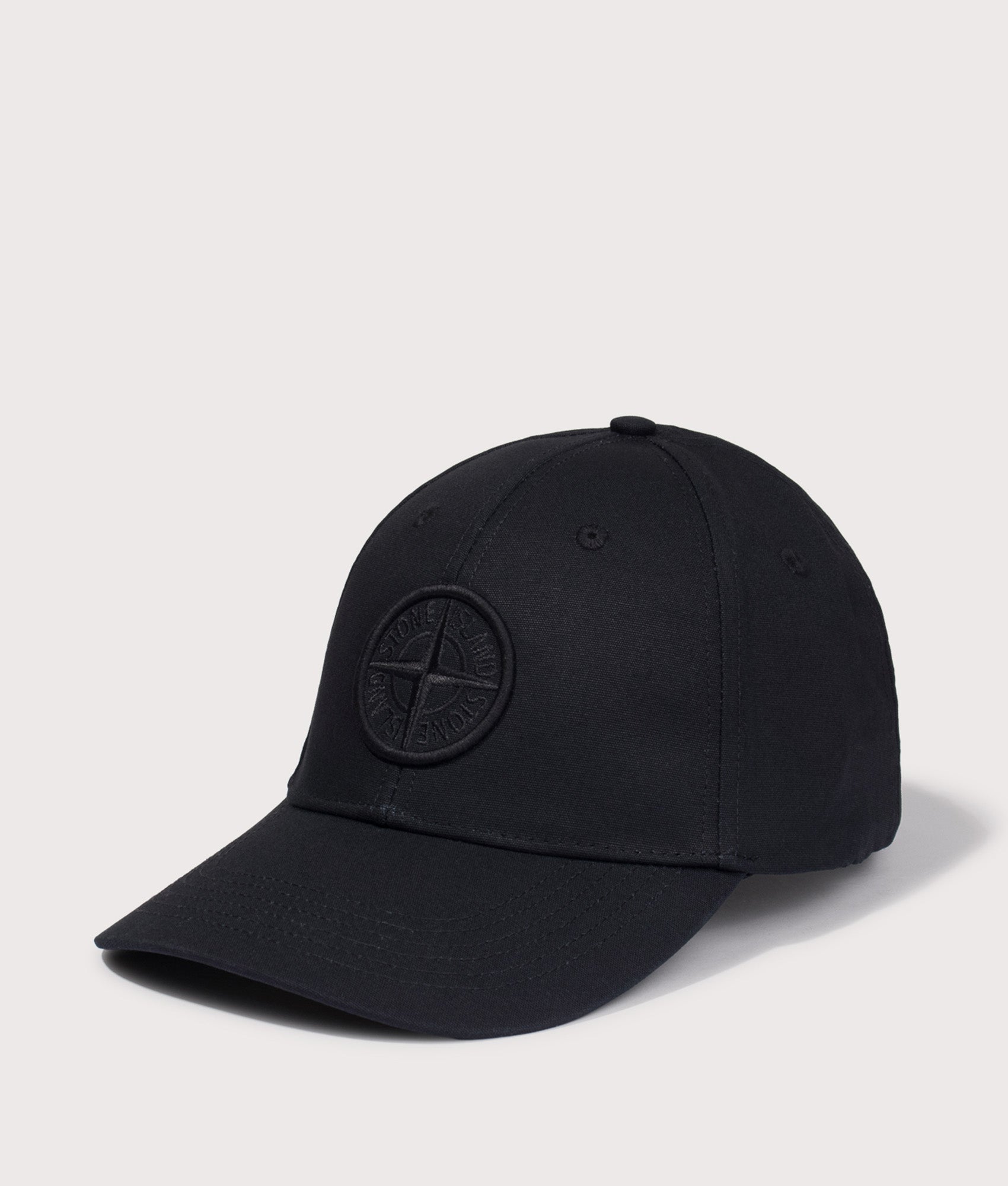 Stone Island Cotton Reps Baseball Cap in Black at EQVVS Menswear. Angled front shot.