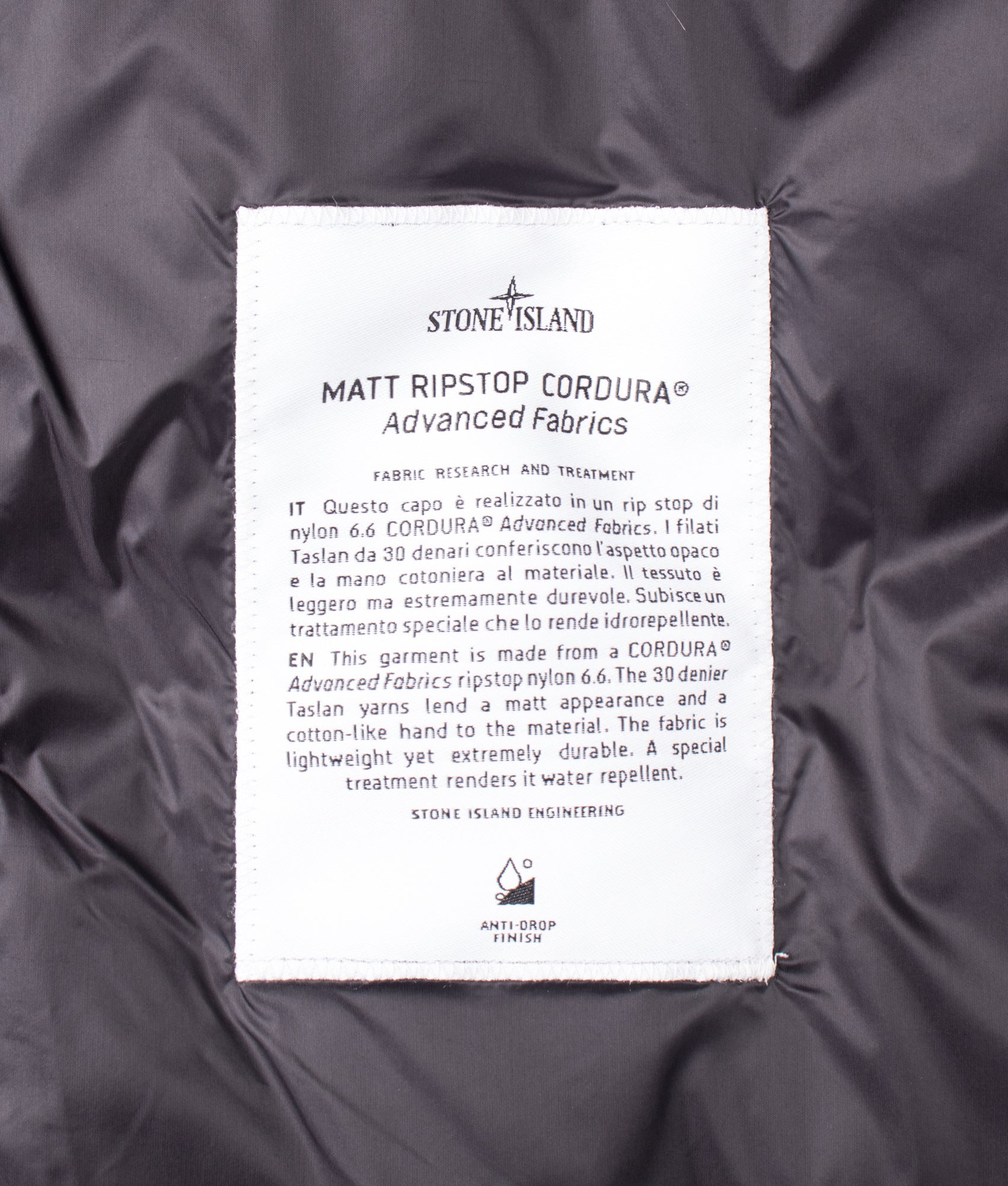 Stone Island Matt Ripstop Cordura® Advanced Fabrics Puffer Jacket in Black at EQVVS Menswear. Label shot.