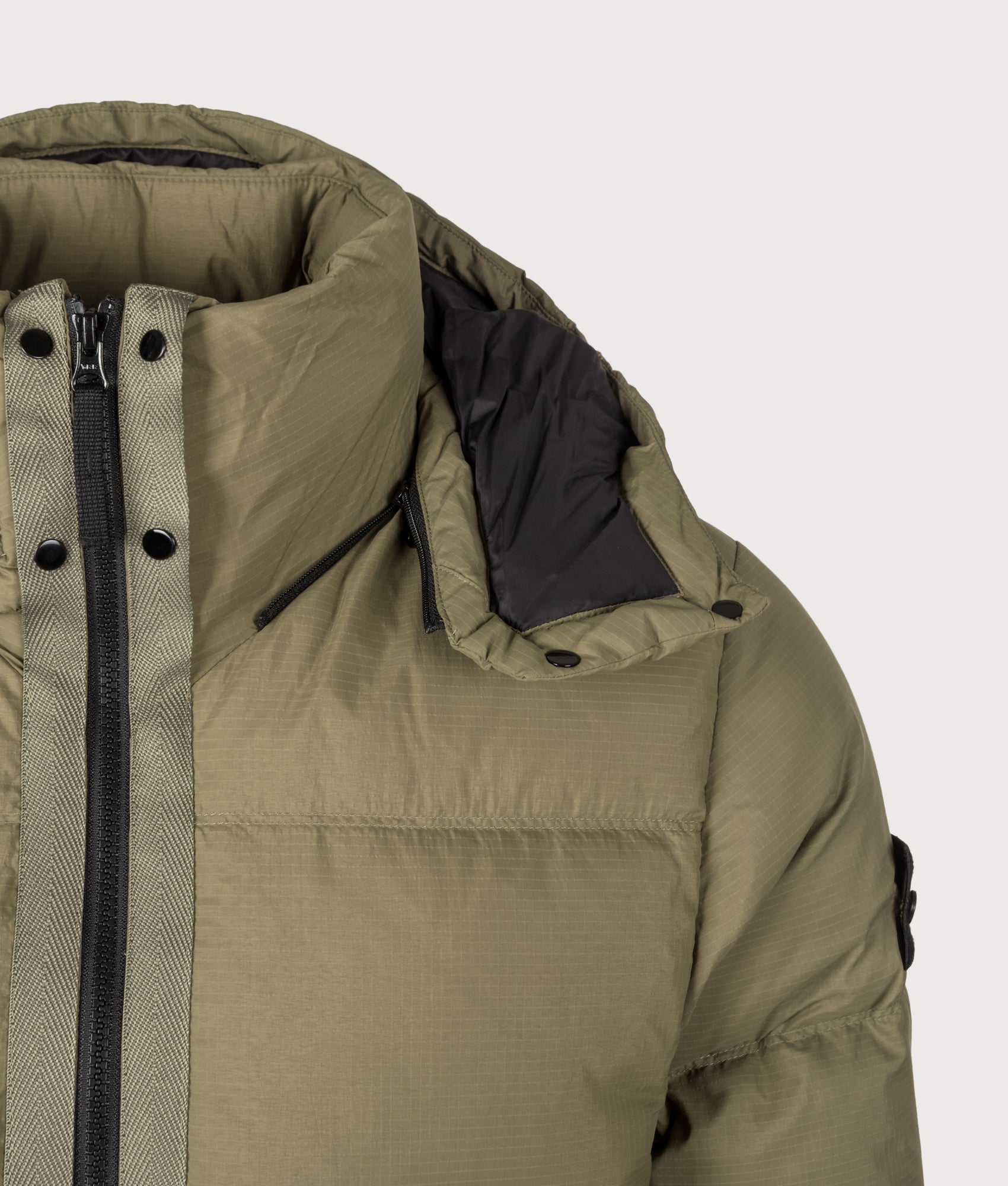 Stone Island Matt Ripstop Cordura® Advanced Fabrics Puffer Jacket in Military Green at EQVVS Menswear. Hood detail shot.