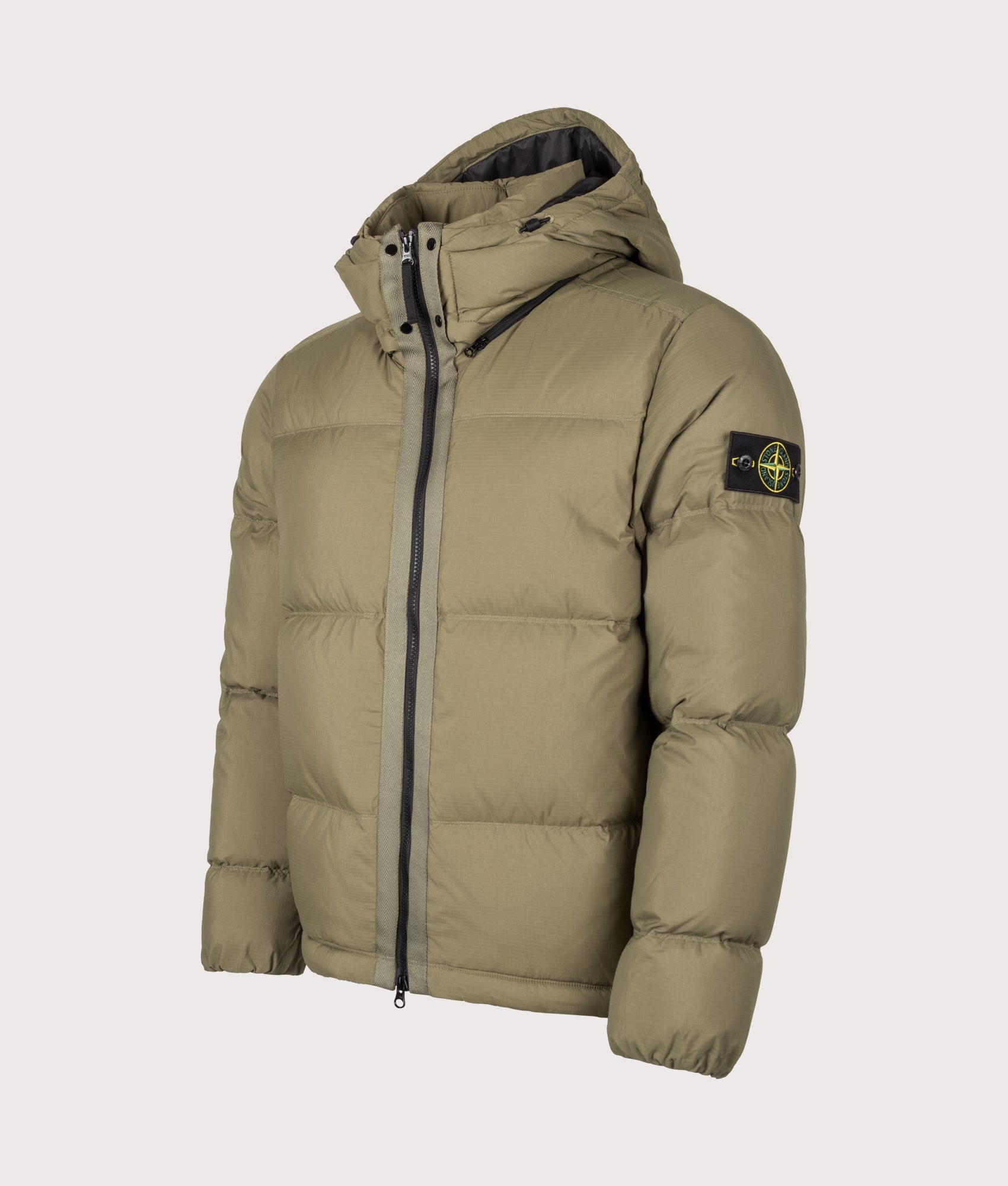 Stone Island Matt Ripstop Cordura® Advanced Fabrics Puffer Jacket in Military Green at EQVVS Menswear. Angled front shot.