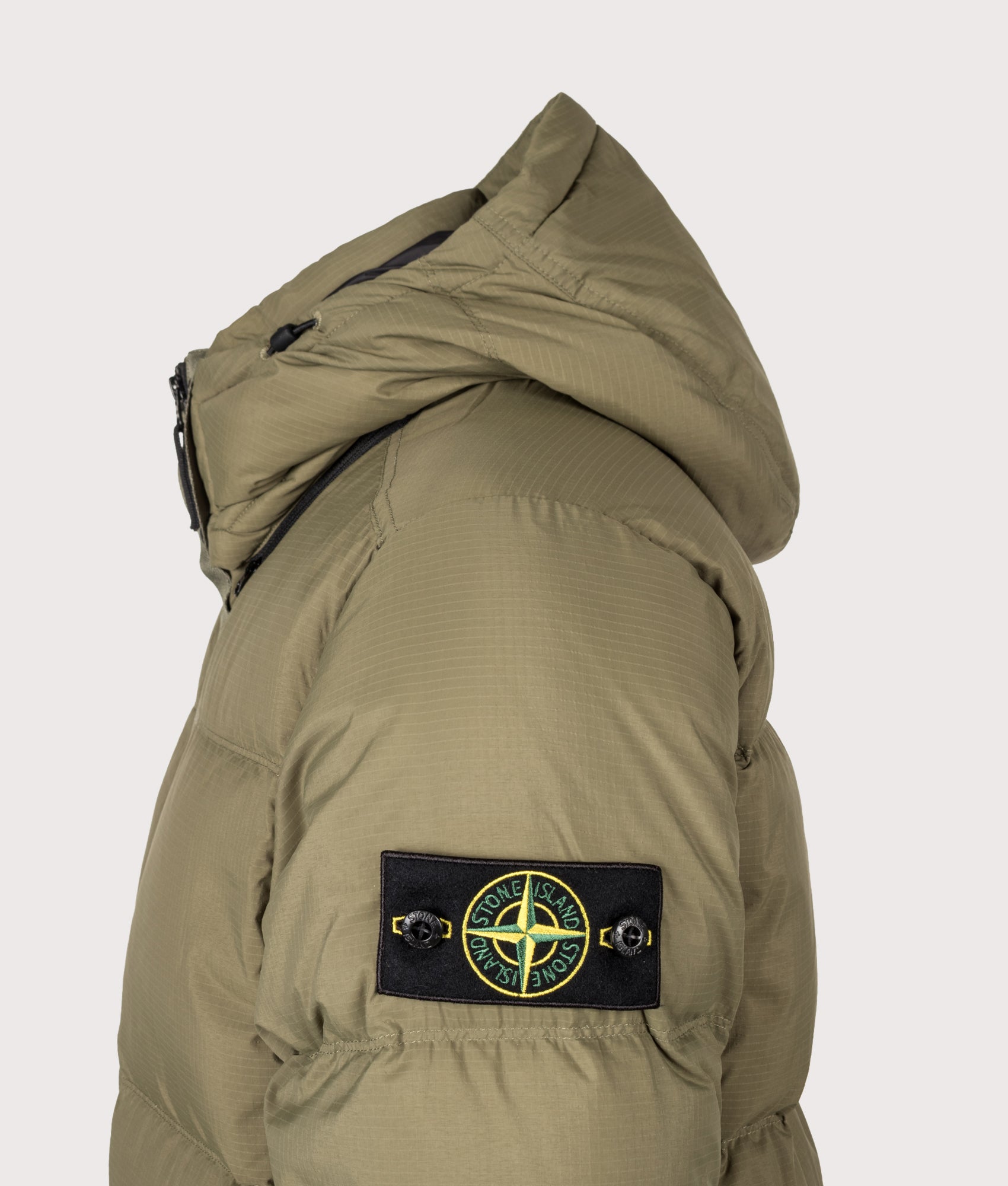 Stone Island Matt Ripstop Cordura® Advanced Fabrics Puffer Jacket in Military Green at EQVVS Menswear. Detail shot.