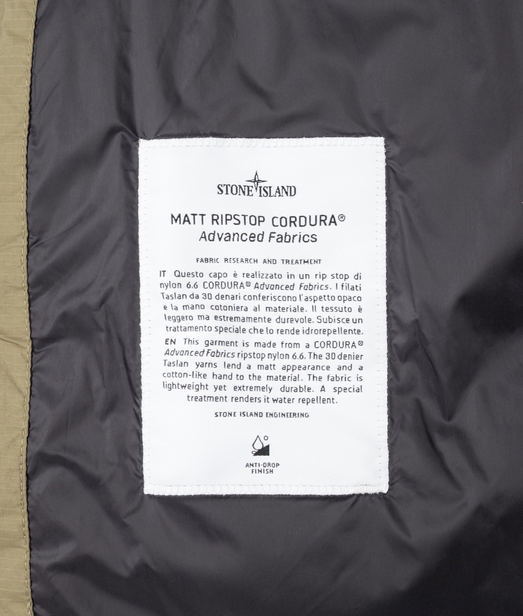 Stone Island Matt Ripstop Cordura® Advanced Fabrics Puffer Jacket in Military Green at EQVVS Menswear. Label shot.
