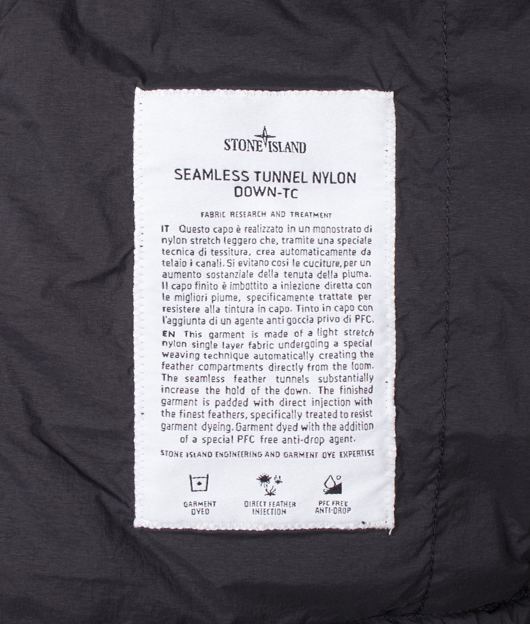 Stone Island Seamless Tunnel Nylon Down-TC Jacket in Black at EQVVS Menswear. Label shot.