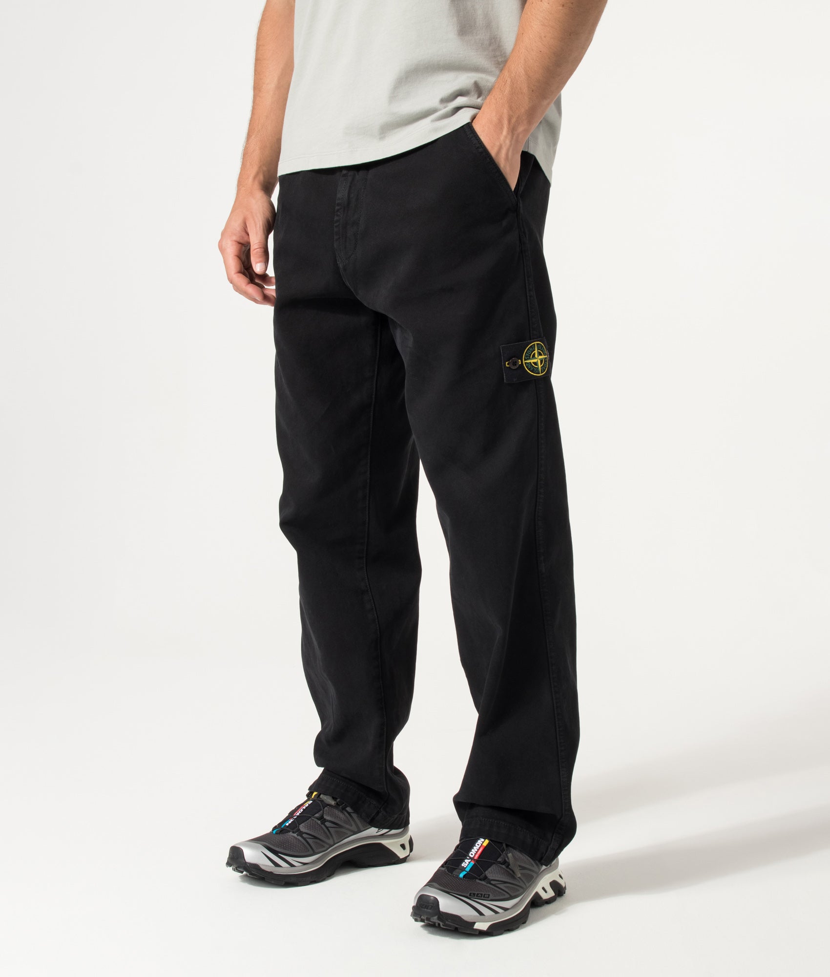Stone Island Loose Fit Organic Panama Cotton 'Old' Effect Trousers in Black at EQVVS Menswear. Angled model front shot.