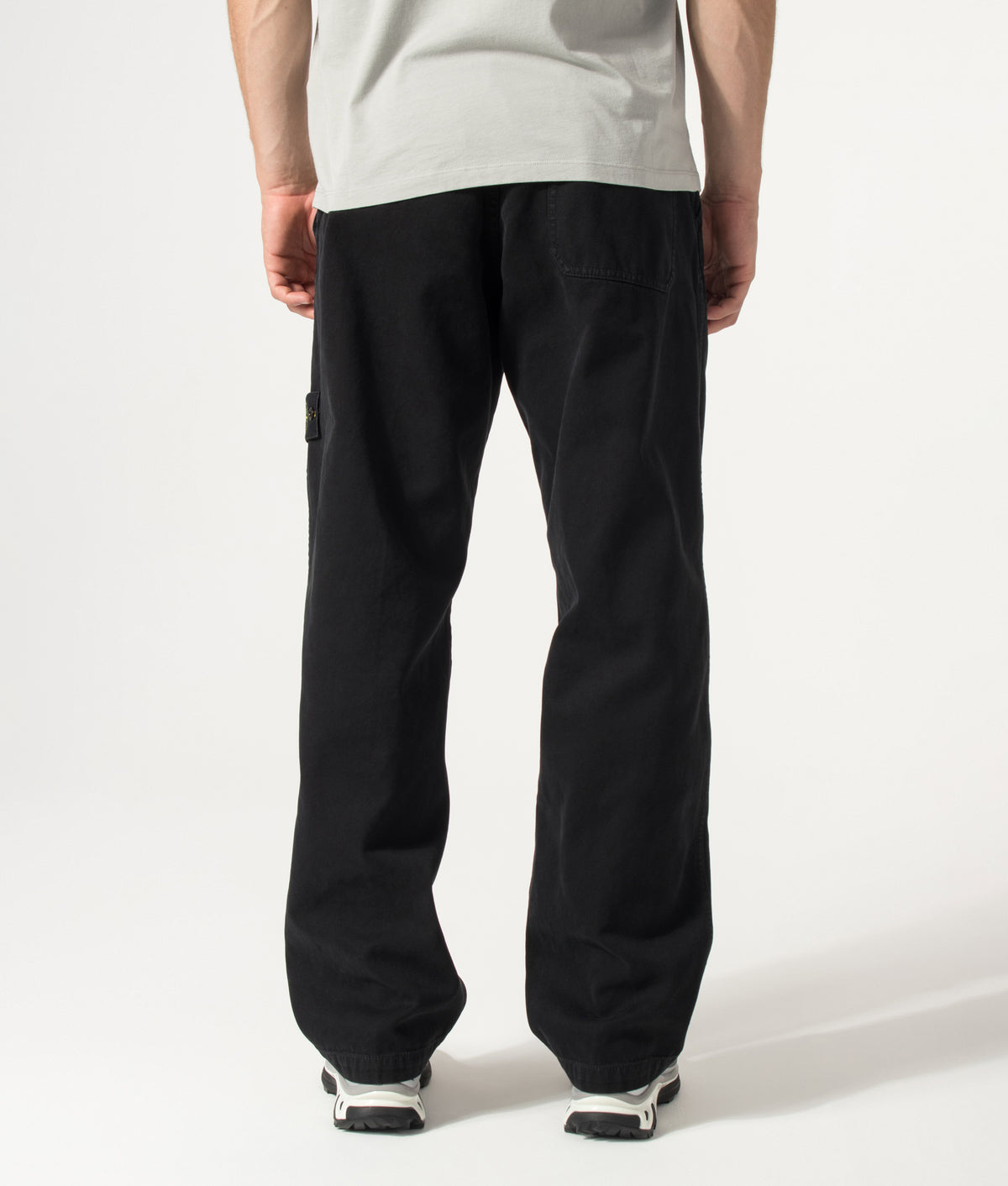Stone Island Loose Fit Organic Panama Cotton 'Old' Effect Trousers in Black at EQVVS Menswear. Model back shot.