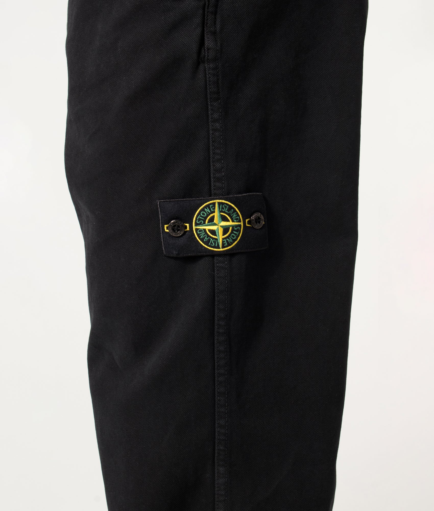 Stone Island Loose Fit Organic Panama Cotton 'Old' Effect Trousers in Black at EQVVS Menswear. Detail shot.