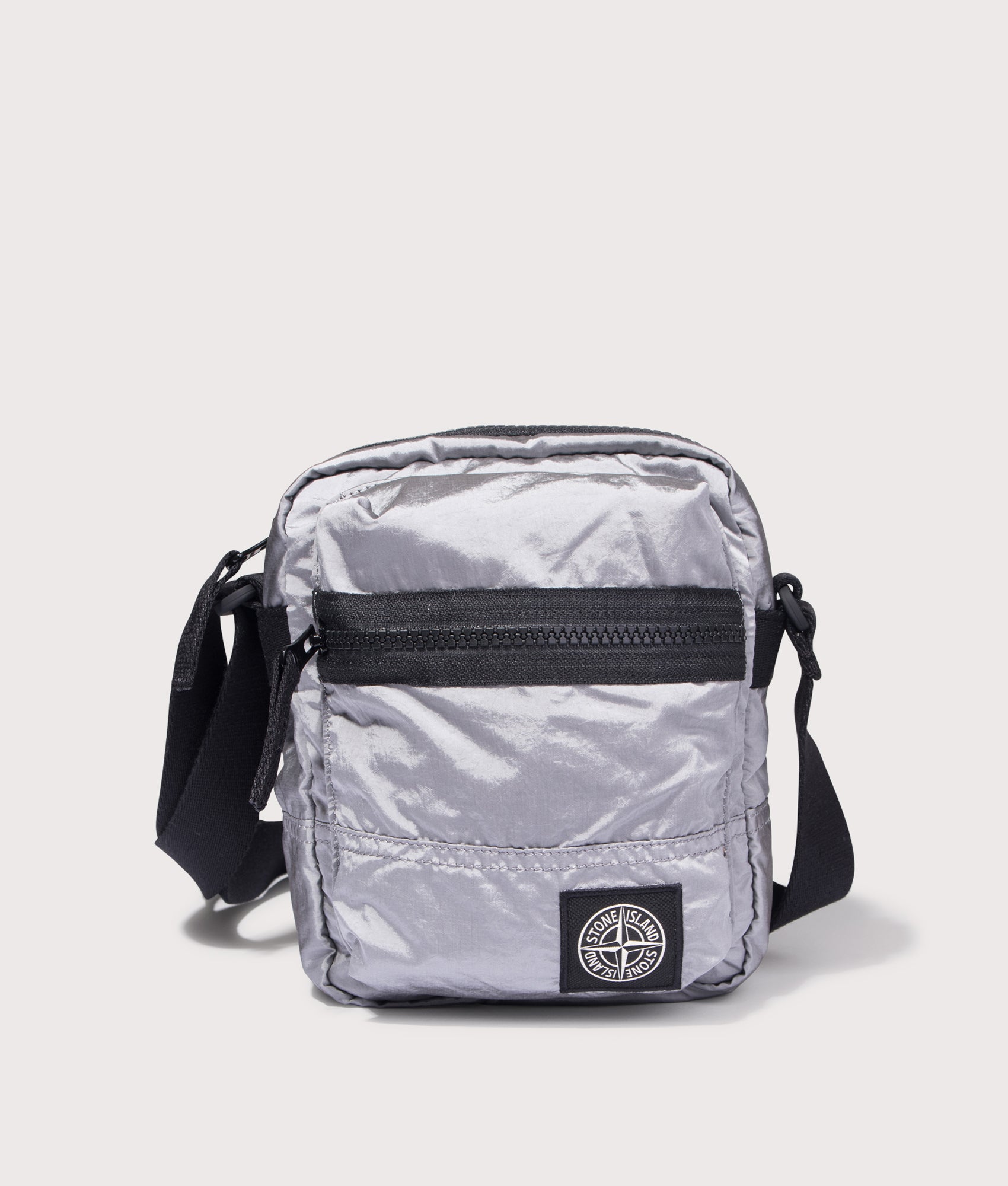 Stone Island Cross Body Sleeve Body Bag in Pearl Grey at EQVVS Menswear. Front shot.