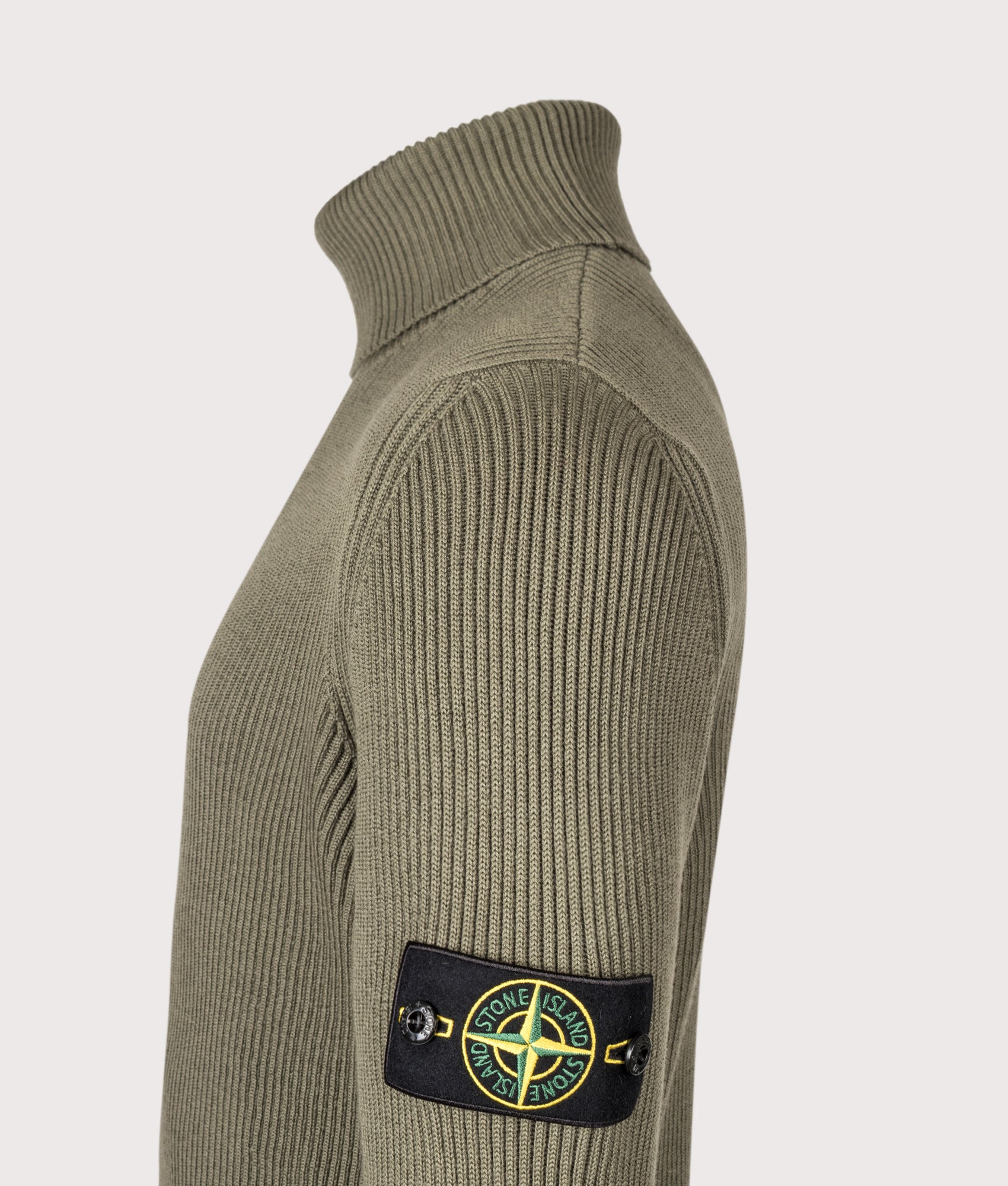 Stone Island Full Rib RWS Wool Turtle Neck Jumper in Military Green at EQVVS Menswear. Detail shot.
