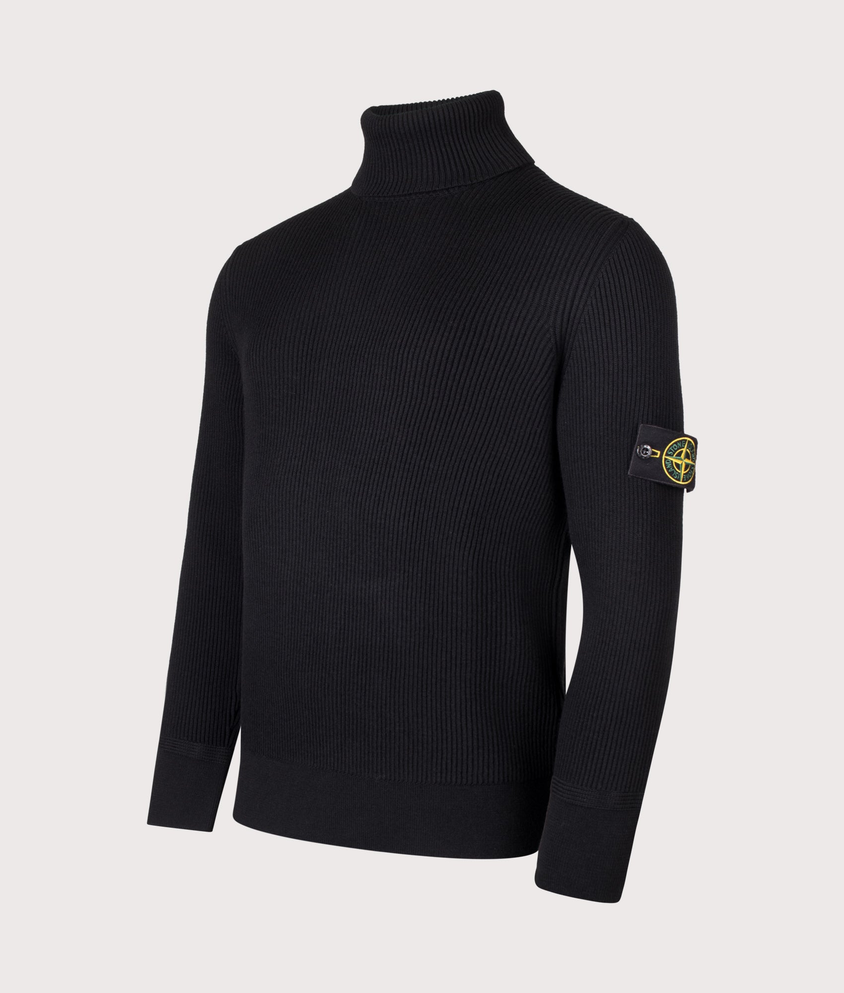 Stone Island Full Rib RWS Wool Turtle Neck Jumper in Black at EQVVS Menswear. Angled front shot.
