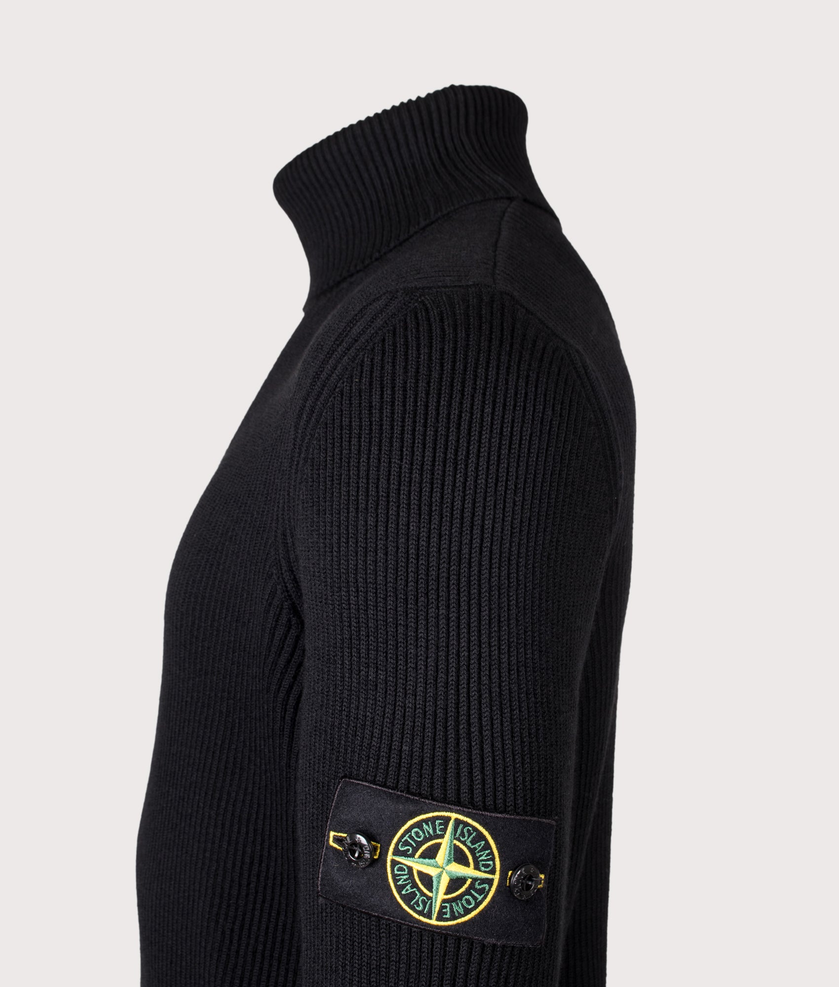 Stone Island Full Rib RWS Wool Turtle Neck Jumper in Black at EQVVS Menswear. Detail shot.