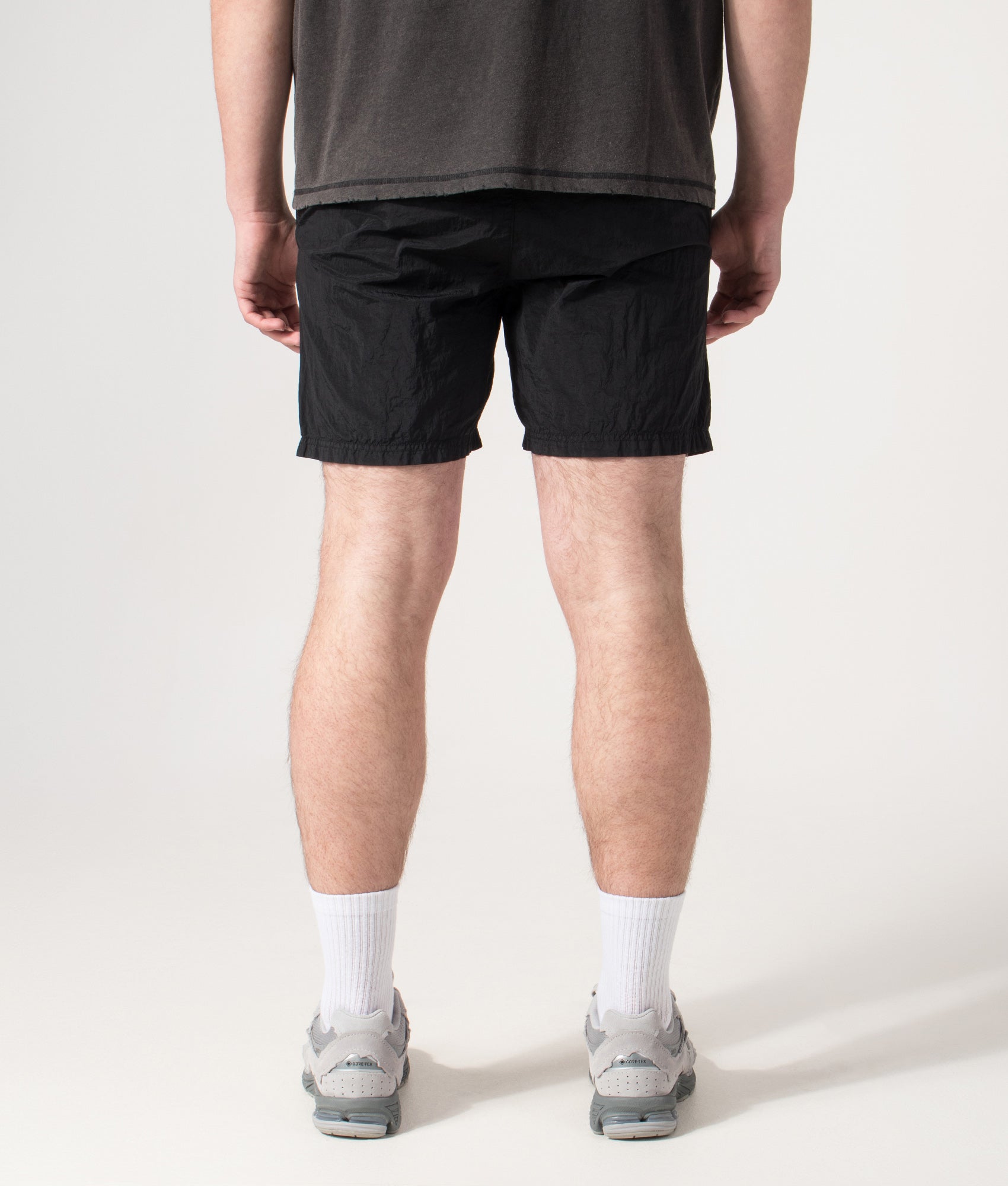 Stone Island Compass Swim Shorts in Black at EQVVS Menswear. Back shot.