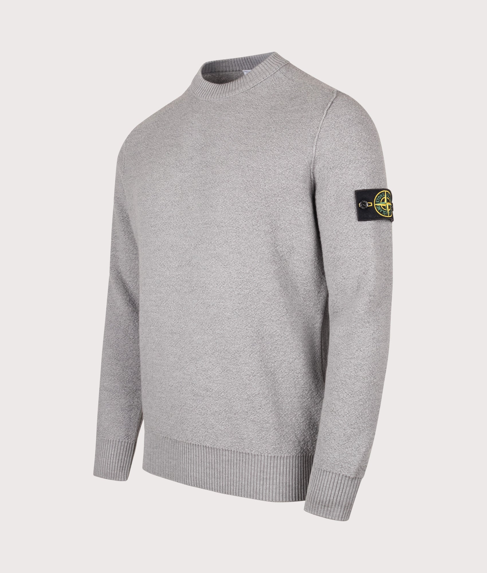 Stone Island Loose Fit Pure RWS Wool Jumper in Ash Grey at EQVVS Menswear. Angled front shot.