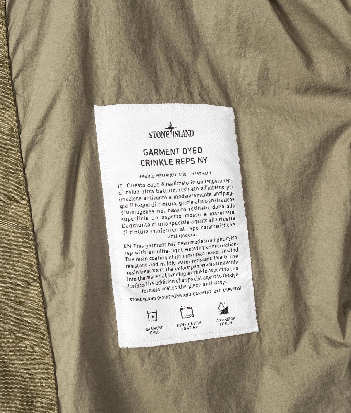 Stone Island Garment Dyed Crinkle Reps NY Down Jacket in Military Green at EQVVS Menswear. Label shot.