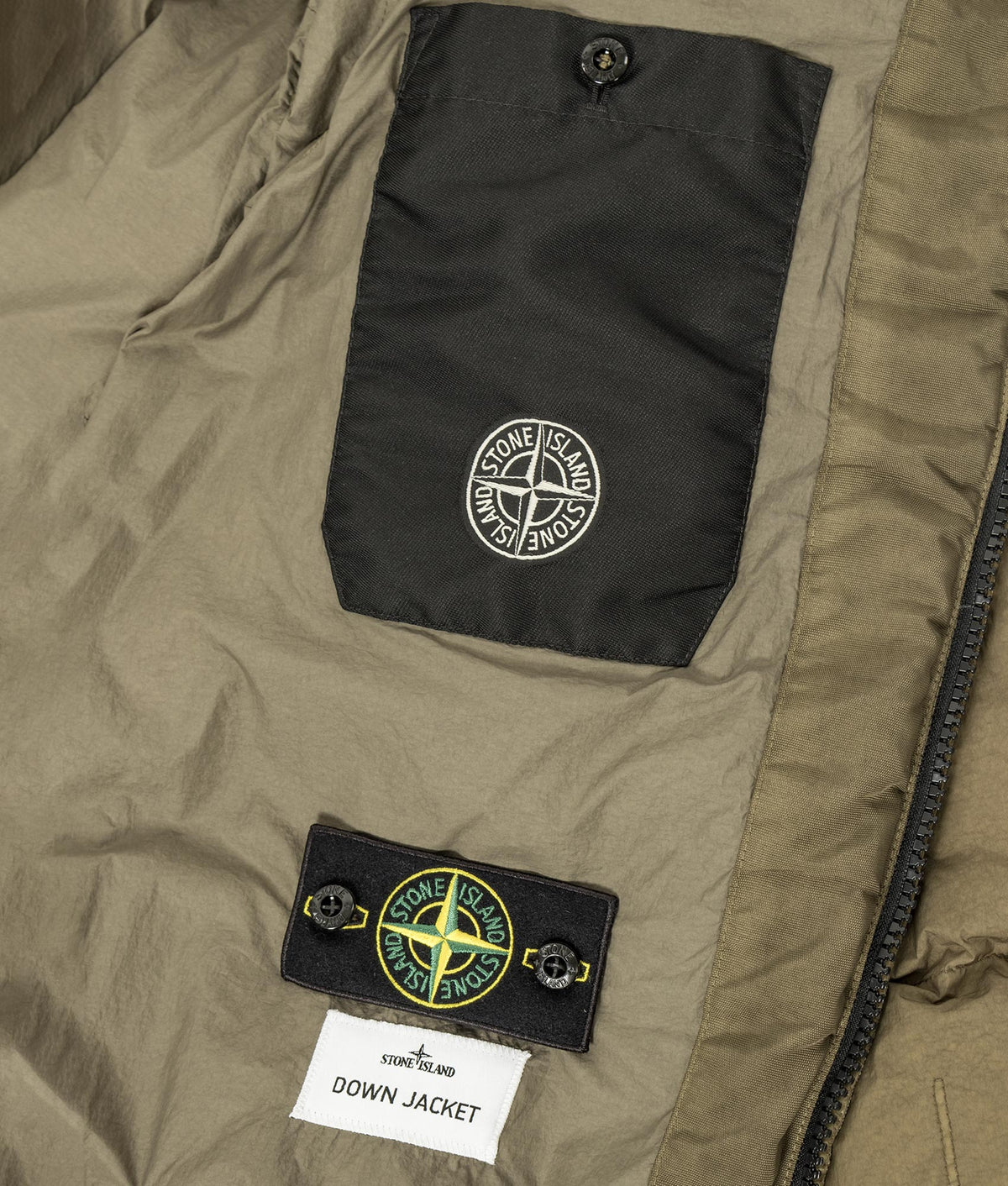 Stone Island Garment Dyed Crinkle Reps NY Down Jacket in Military Green at EQVVS Menswear. Second detail shot.