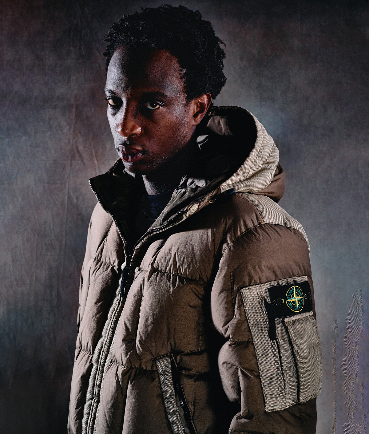 Stone Island Garment Dyed Crinkle Reps NY Down Jacket in Military Green at EQVVS Menswear. Campaign shot.
