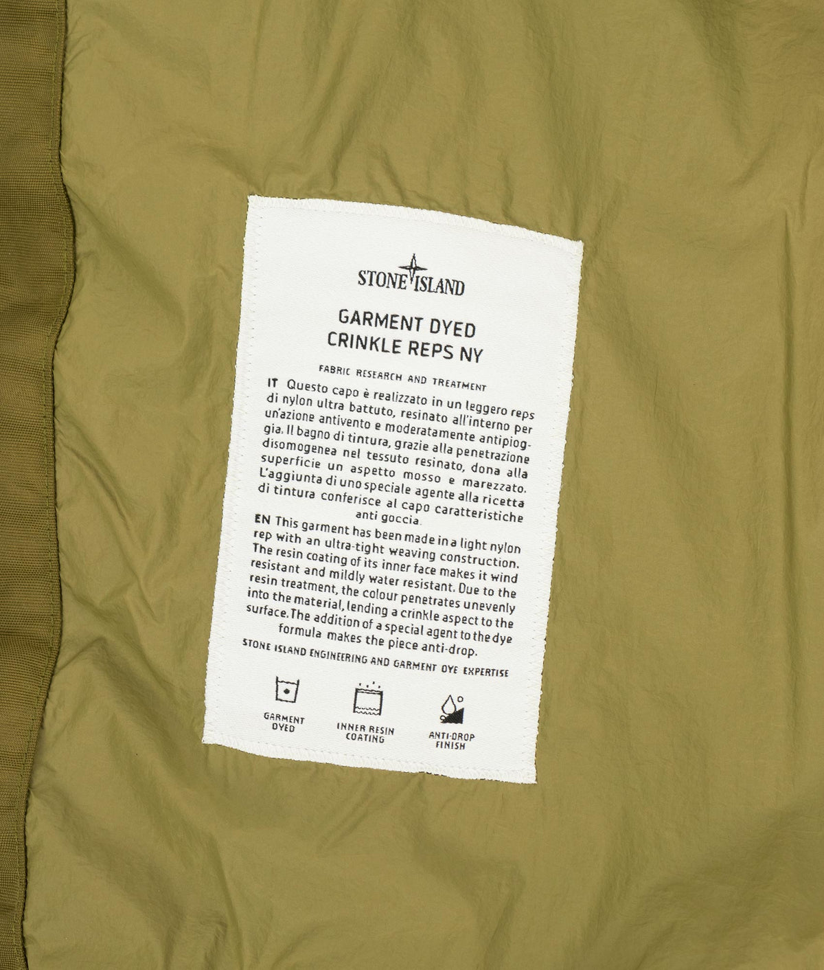 Stone Island Garment Dyed Crinkle Reps NY Down Jacket in Cactus at EQVVS Menswear. Label shot.