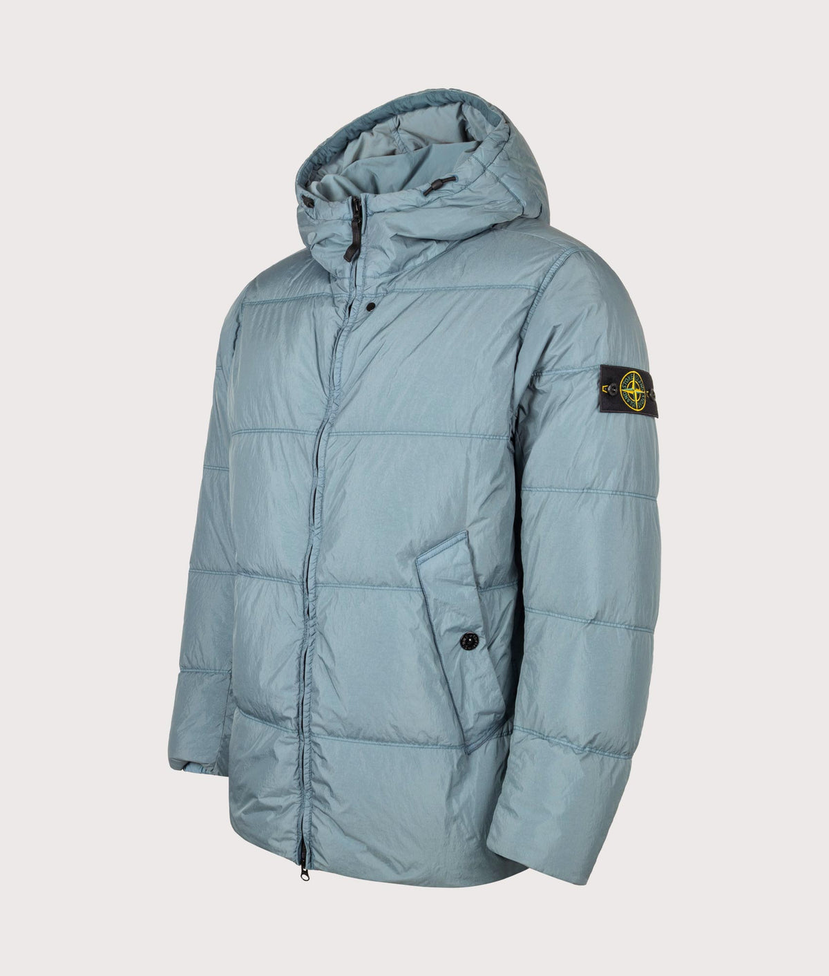 Stone Island Crinkle Reps NY Puffer Jacket in Steel Blue at EQVVS Menswear. Angled front shot.