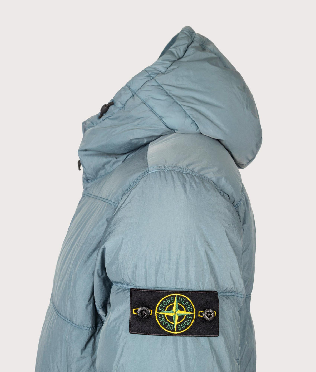 Stone Island Crinkle Reps NY Puffer Jacket in Steel Blue at EQVVS Menswear. Detail shot.
