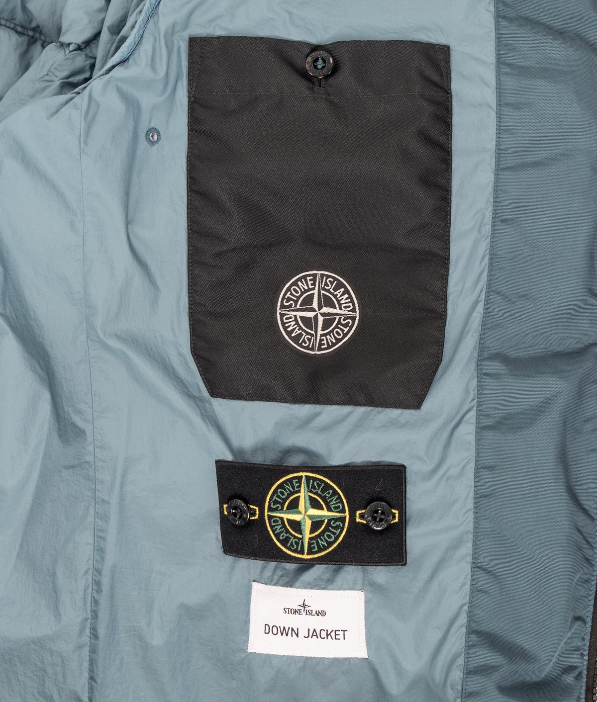 Stone Island Crinkle Reps NY Puffer Jacket in Steel Blue at EQVVS Menswear. Second detail shot.
