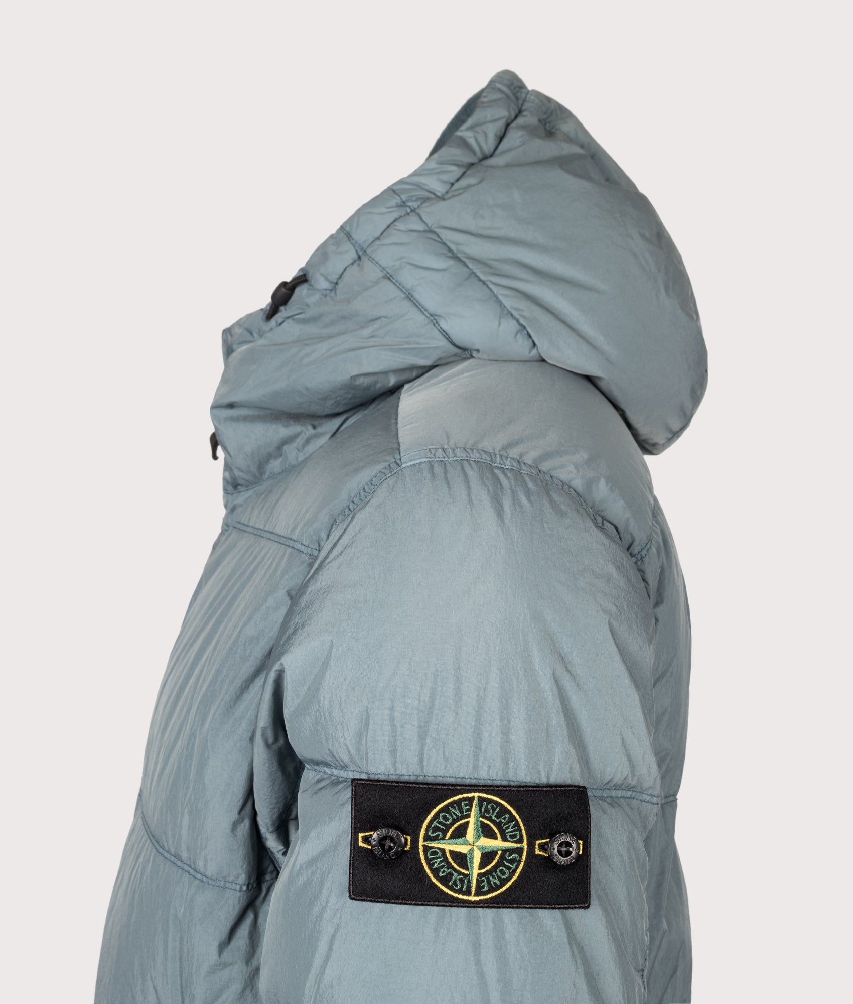 Stone Island Crinkle Reps NY Puffer Jacket in Steel Blue at EQVVS Menswear. Detail shot.