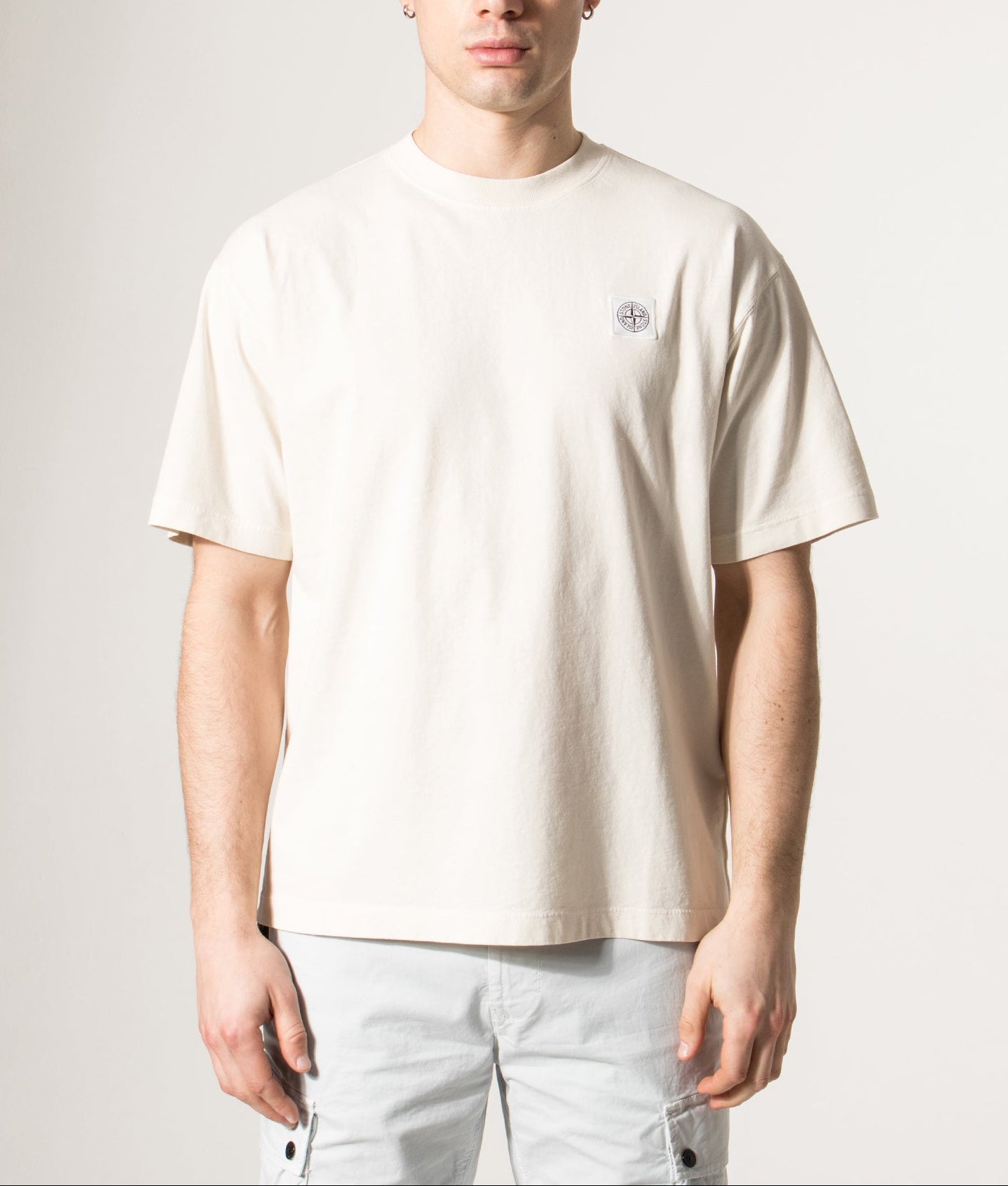 Stone Island Compass Patch T-Shirt in Ivory at EQVVS Menswear. Model front shot.