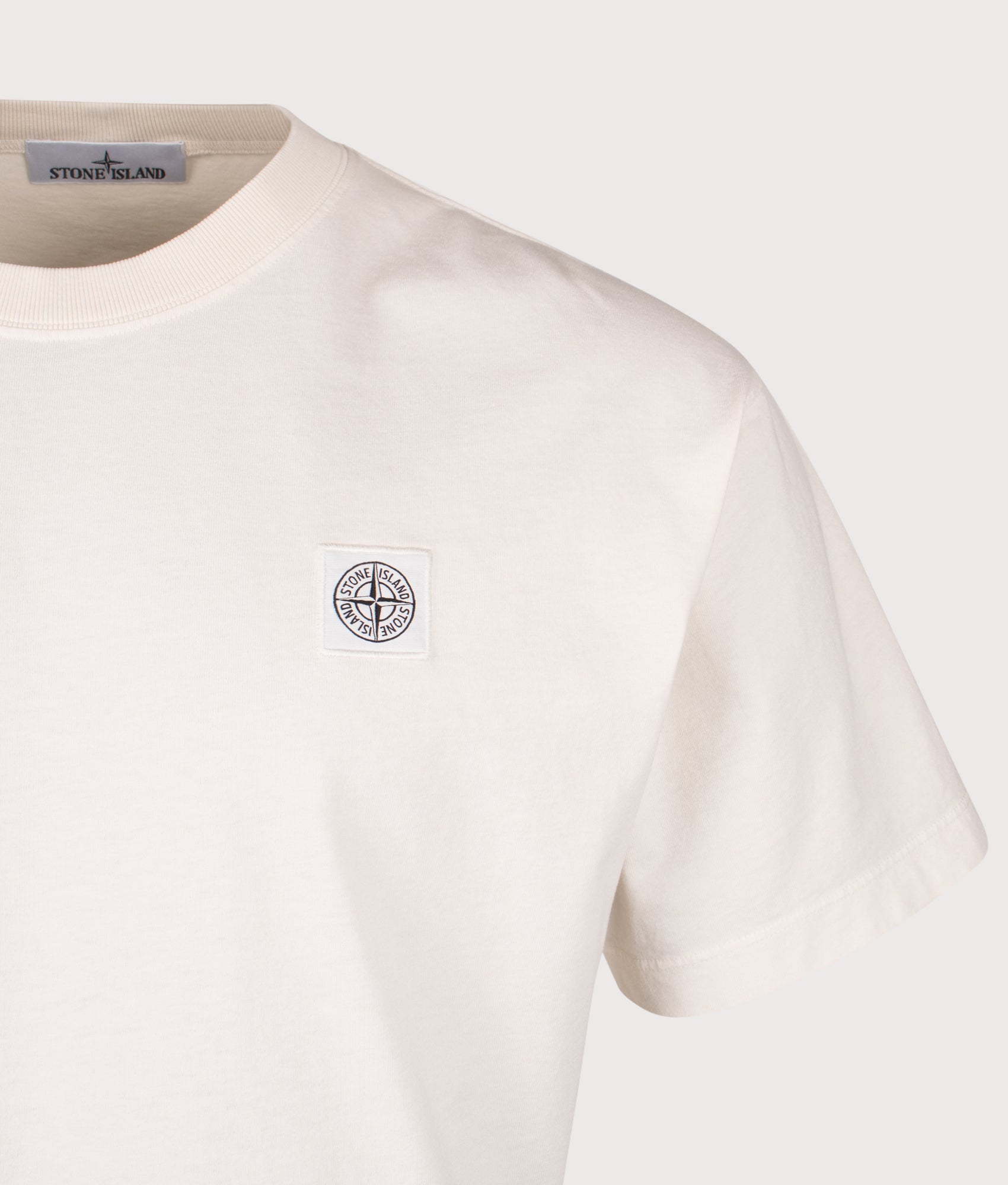 Stone Island Compass Patch T-Shirt in Ivory at EQVVS Menswear. Detail shot. 