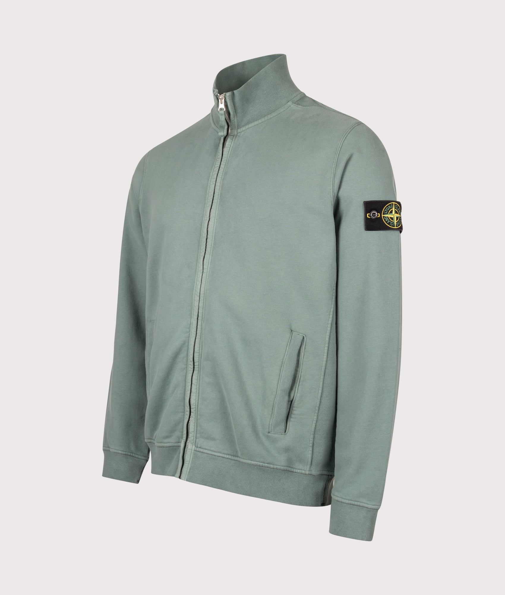 Stone Island Brushed Cotton Zip Through Track Top in Ocean Green at EQVVS Menswear. Angled front shot.