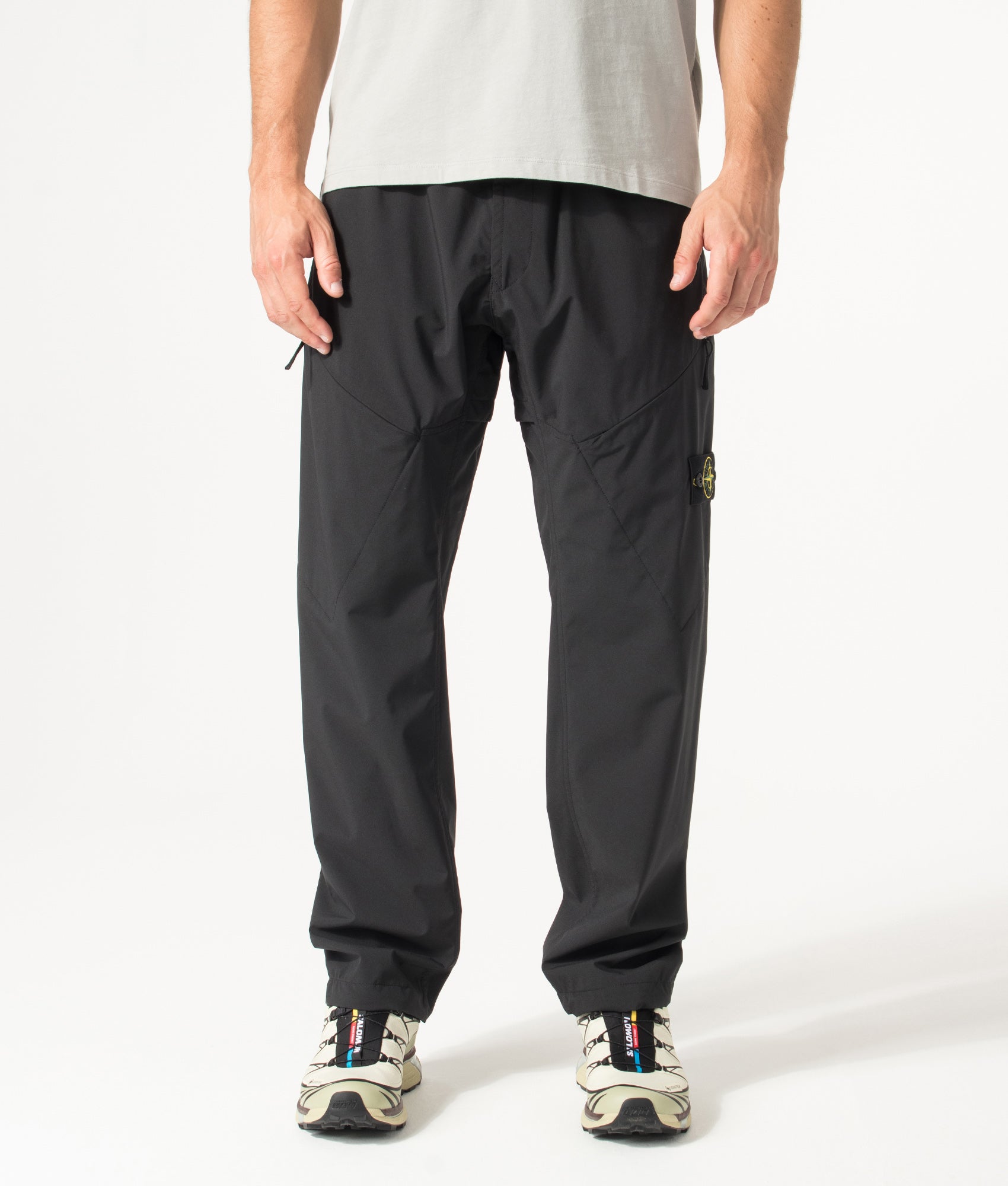 Stone Island Regular Fit Soft Shell-R_E. Dye® Technology Trousers in Black at EQVVS Menswear. Model front shot.