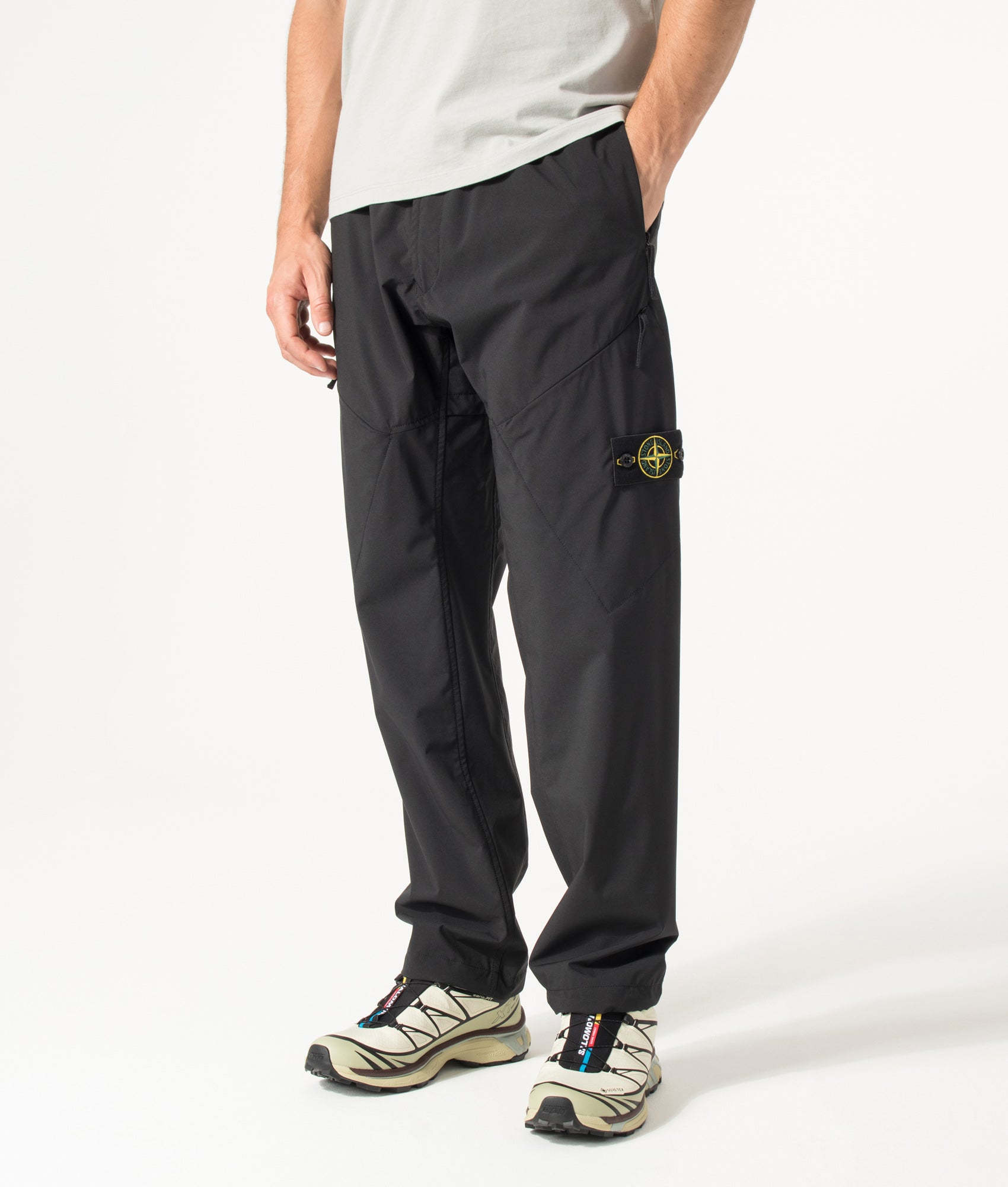 Stone Island Regular Fit Soft Shell-R_E. Dye® Technology Trousers in Black at EQVVS Menswear. Angled model front shot.