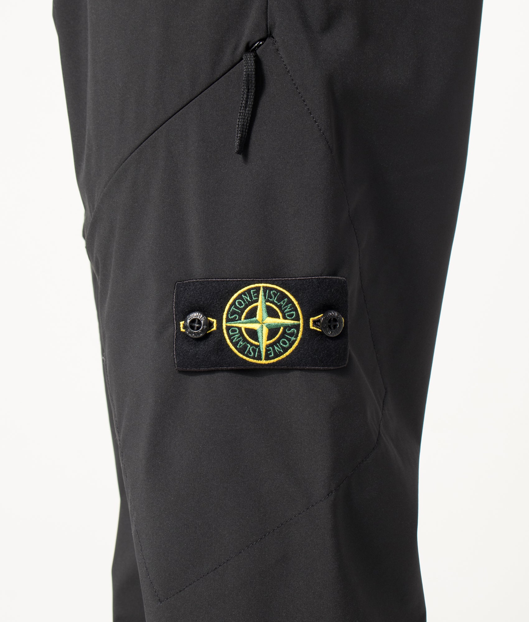 Stone Island Regular Fit Soft Shell-R_E. Dye® Technology Trousers in Black at EQVVS Menswear. Detail shot.