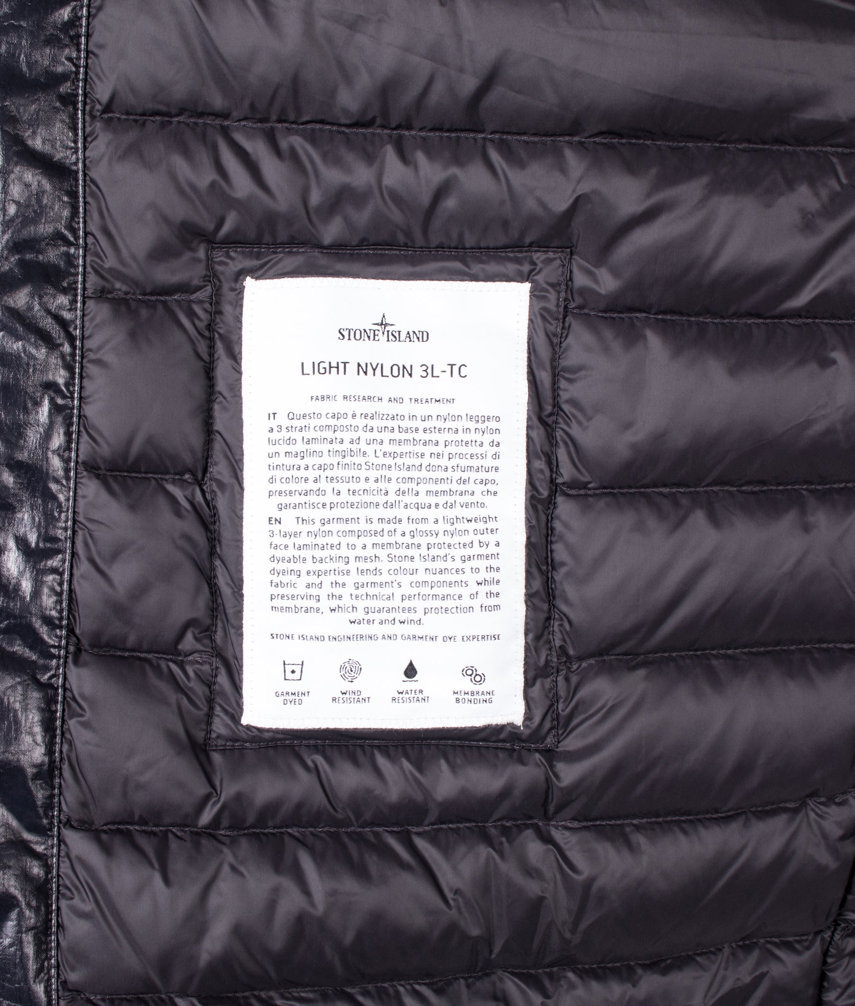 Stone Island Light Nylon 3L-TC Down Jacket in Black at EQVVS Menswear. Label shot.