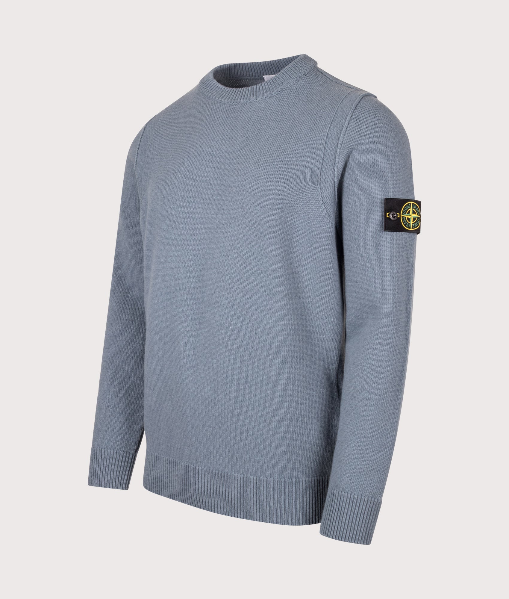 Stone Island Lambswool Crewneck Jumper in Steel Blue at EQVVS Menswear. Angled front shot.