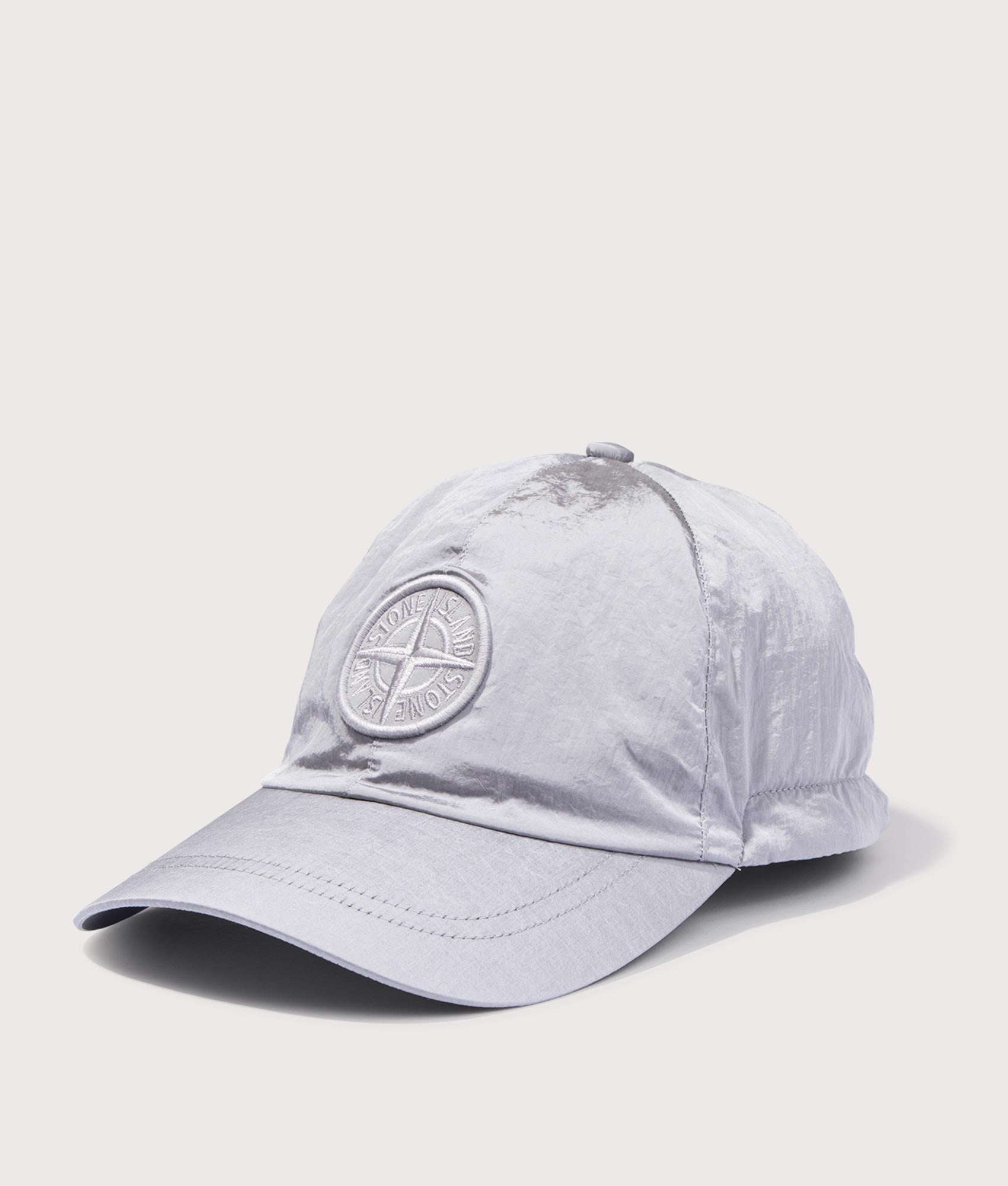 Stone Island Nylon Metal Baseball Cap in Pearl Grey at EQVVS Menswear. Angled front shot.