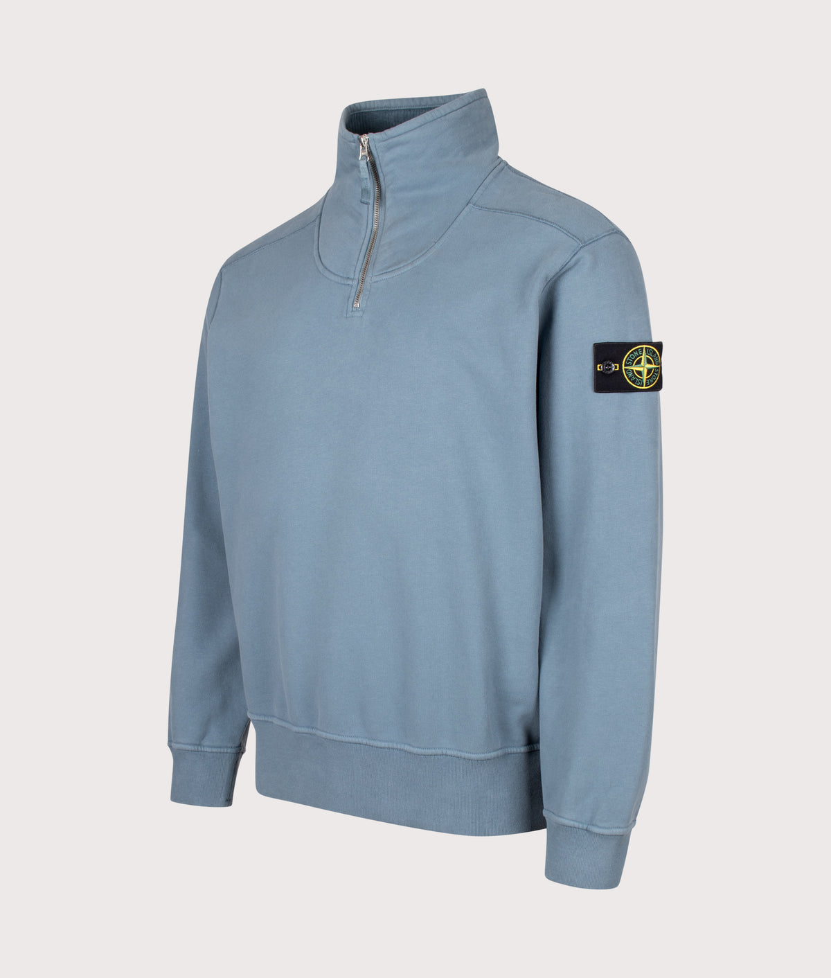 Stone Island Comfort Fit Brushed Organic Fleece Quarter Zip Sweatshirt in Steel Blue at EQVVS Menswear. Angled front shot.