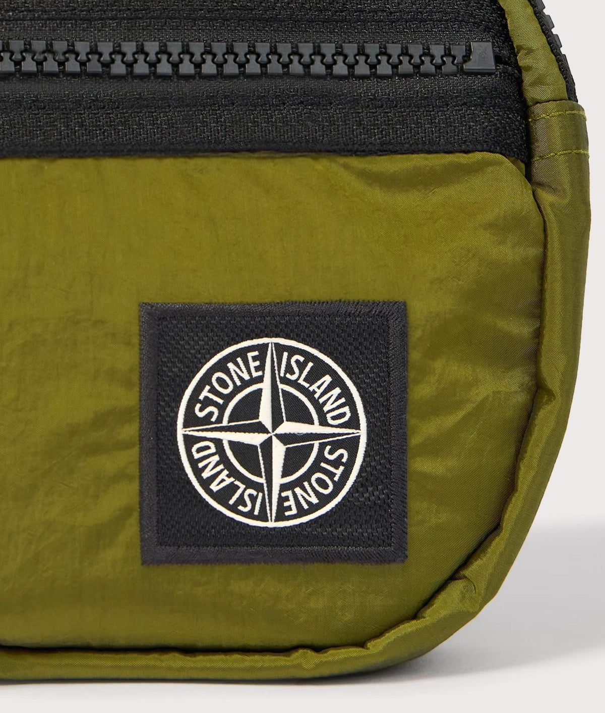 Stone Island Coated Nylon Metal in Econyl® Belt Bag in Cactus at EQVVS Menswear. Detail shot.