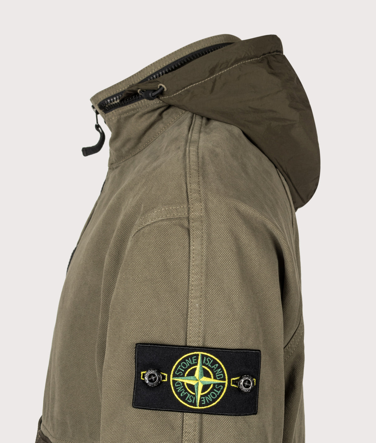 Stone Island Zip Through Lightweight Hooded Jacket in Military Green at EQVVS Menswear. Detail shot.