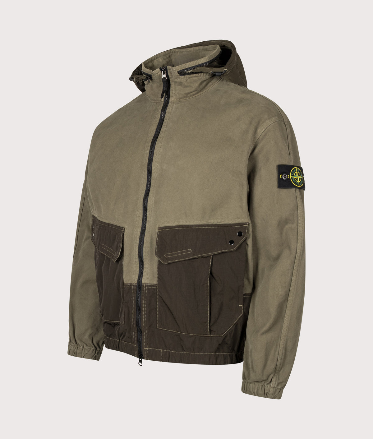 Stone Island Zip Through Lightweight Hooded Jacket in Military Green at EQVVS Menswear. Angled front shot.