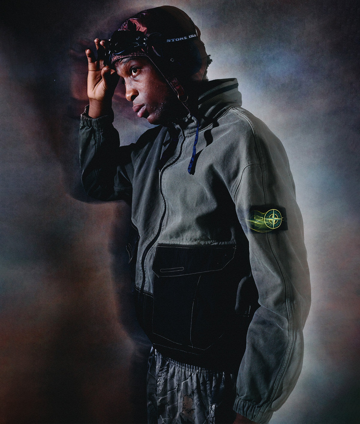Stone Island Zip Through Lightweight Hooded Jacket in Military Green at EQVVS Menswear. Campaign shot.