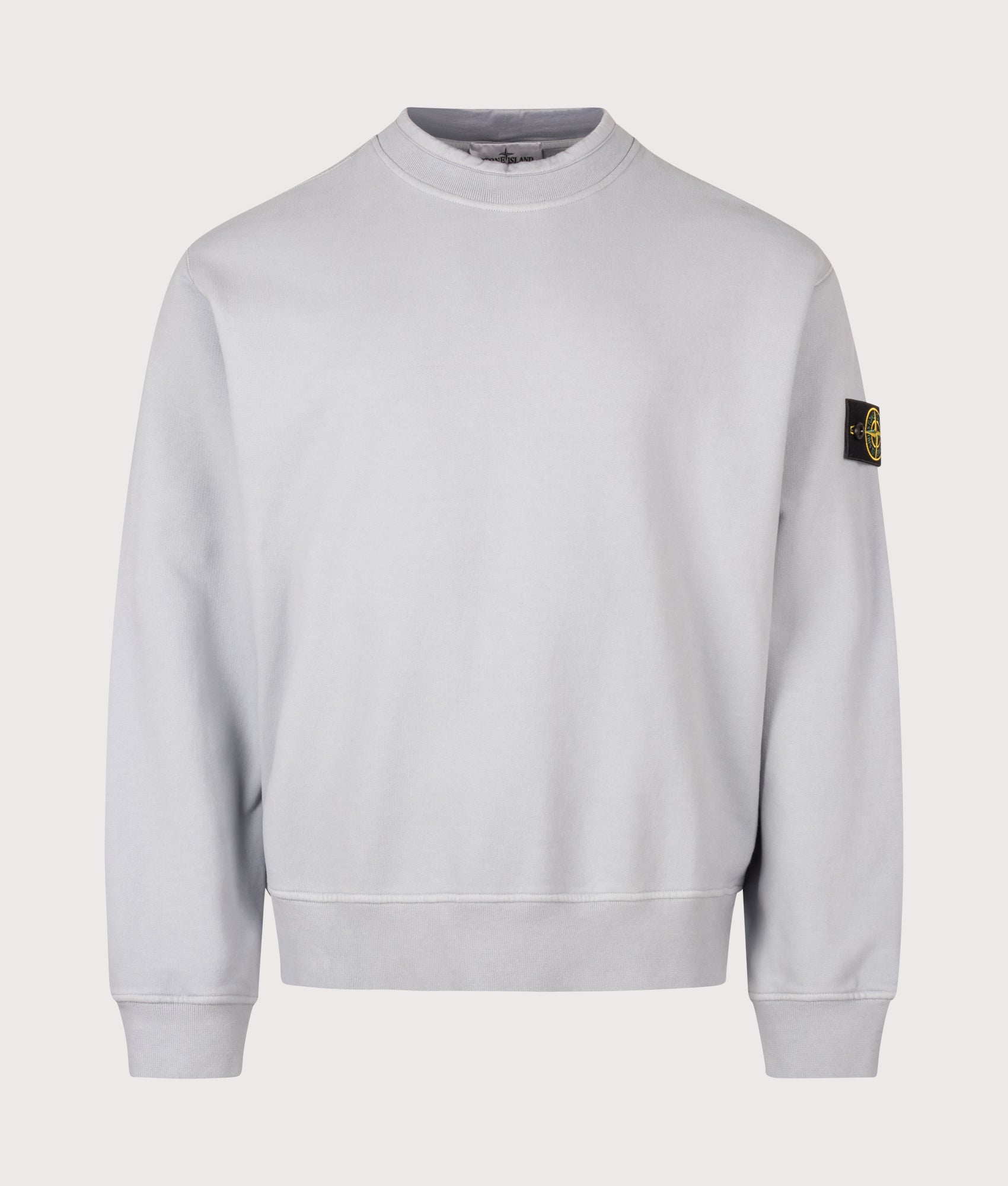 Stone Island Oversized Fit Brushed Organic Cotton Fleece Sweatshirt in Ash Grey at EQVVS Menswear. Front shot.
